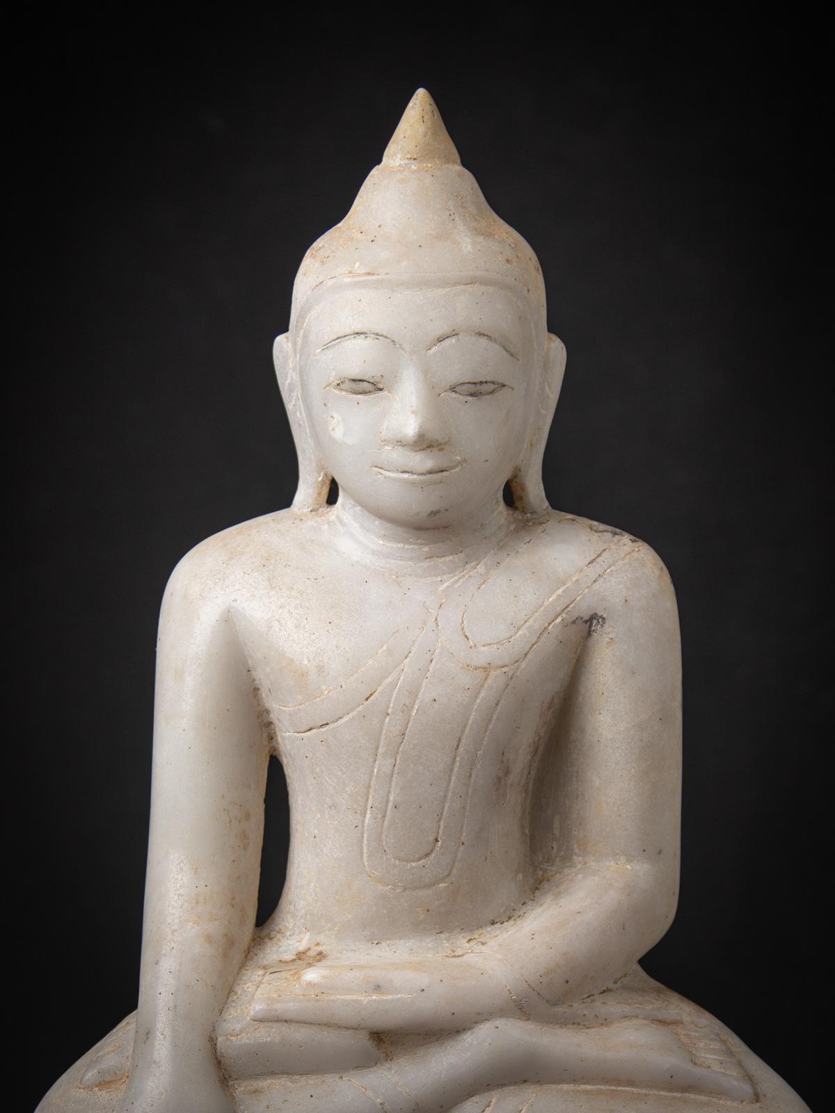 Experience the serenity of this antique marble Burmese Buddha statue, a rare 17th-18th century artifact crafted in the Shan (Tai Yai) style. Carved from solid marble, this exquisite piece stands 58.4 cm high, 33.7 cm wide, and 14.5 cm deep, with a