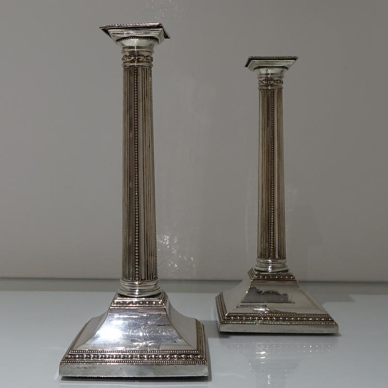 A stunning pair of 18th century bead column square based candlesticks. The pedestal bases have beautiful contrasting decoration with upper and lower ornate borders sandwiching a “sloping” plain formed centre. The detachable nozzles are square in