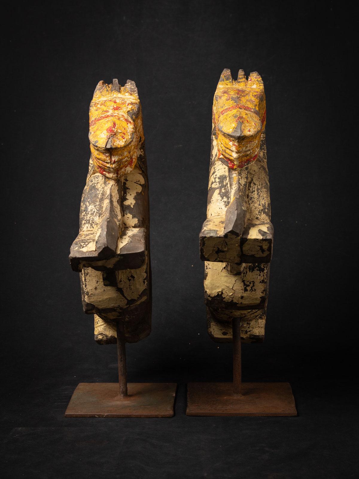 The Antique pair wooden tempelfragments from a horse head is a remarkable and spiritually significant artifact originating from India, each statue stands at 49 cm in height and measures 15,3 cm in width and 37,5  cm in depth. The gilded surface adds