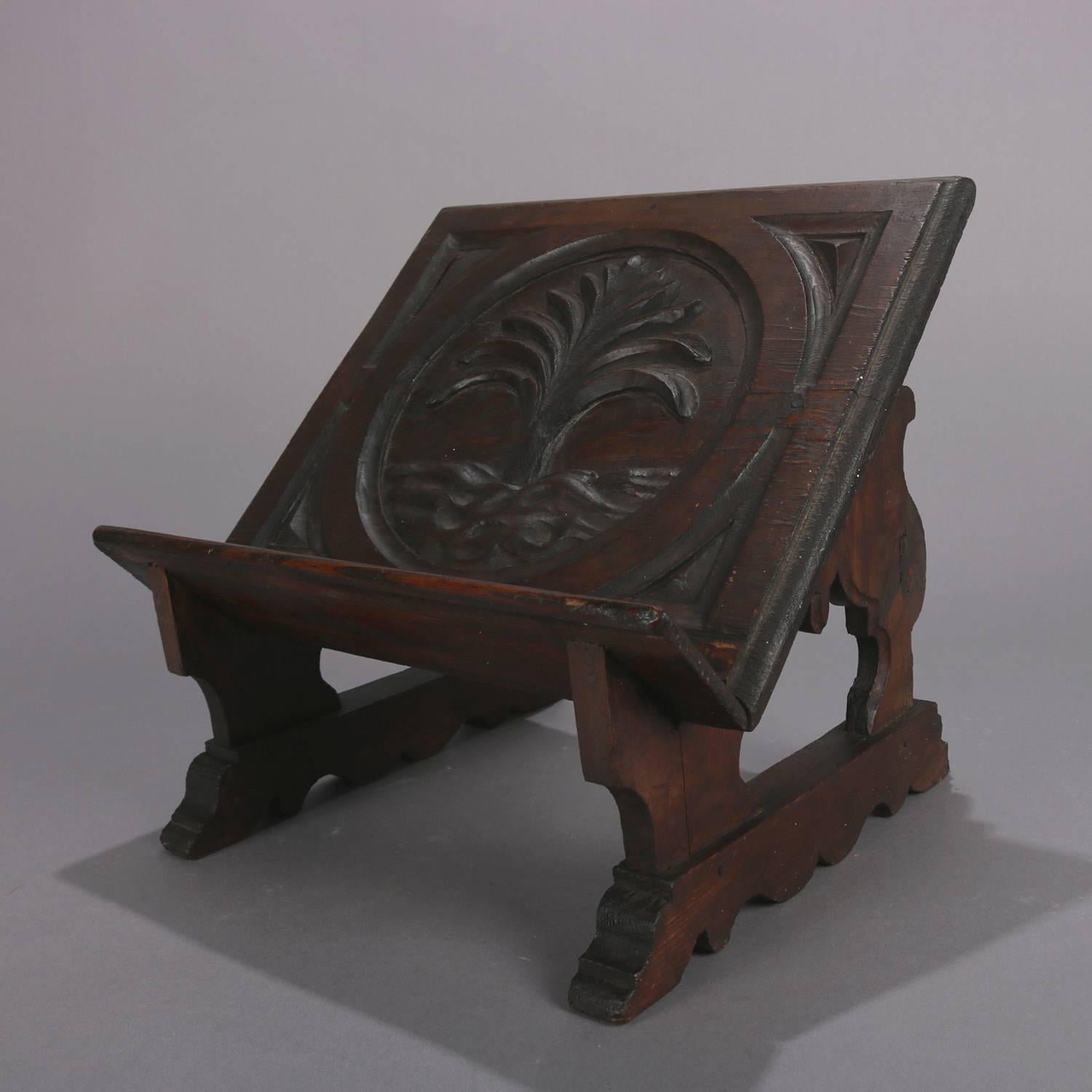 Antique Bible stand features hand-carved pine construction with central stylized tree of life tray seated on scroll and foliate form base, 18th century.

Measures: 12