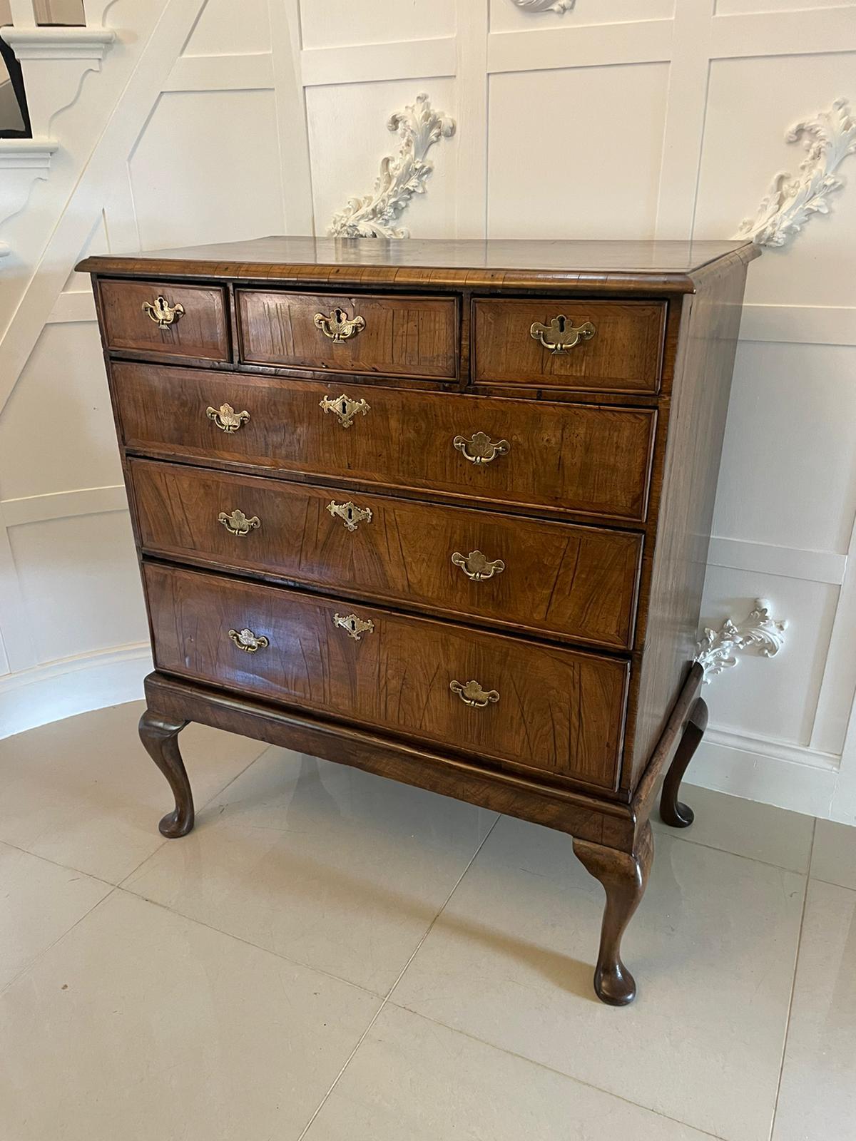 18th century antique quality walnut chest on stand having a quality figured walnut crossbanded top with a moulded edge above three short and three long figured walnut quality oak lined drawers with herringbone crossbanding and a cockbeeded edge,