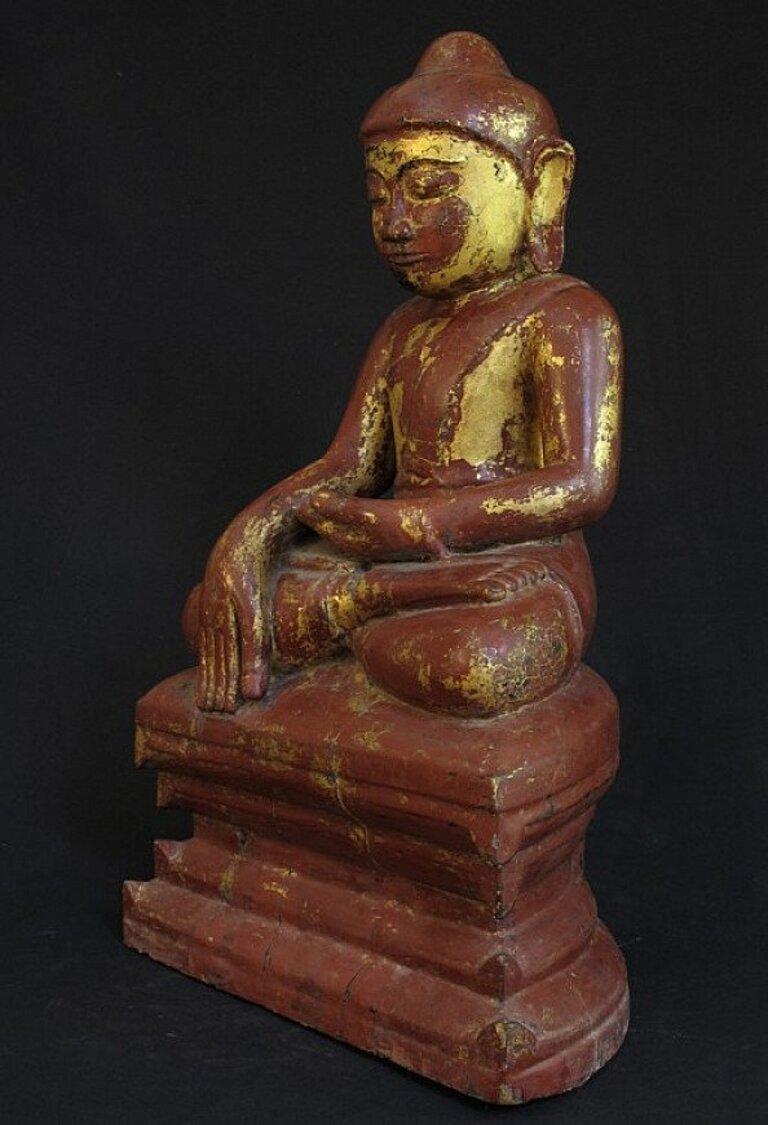 This antique wooden Buddha statue is a truly unique and special collectible piece. Standing at 58 cm high, it is made of wood, and it is depicted in the Bhumisparsha mudra. This statue is believed to originate from Burma, dating back to the 18th