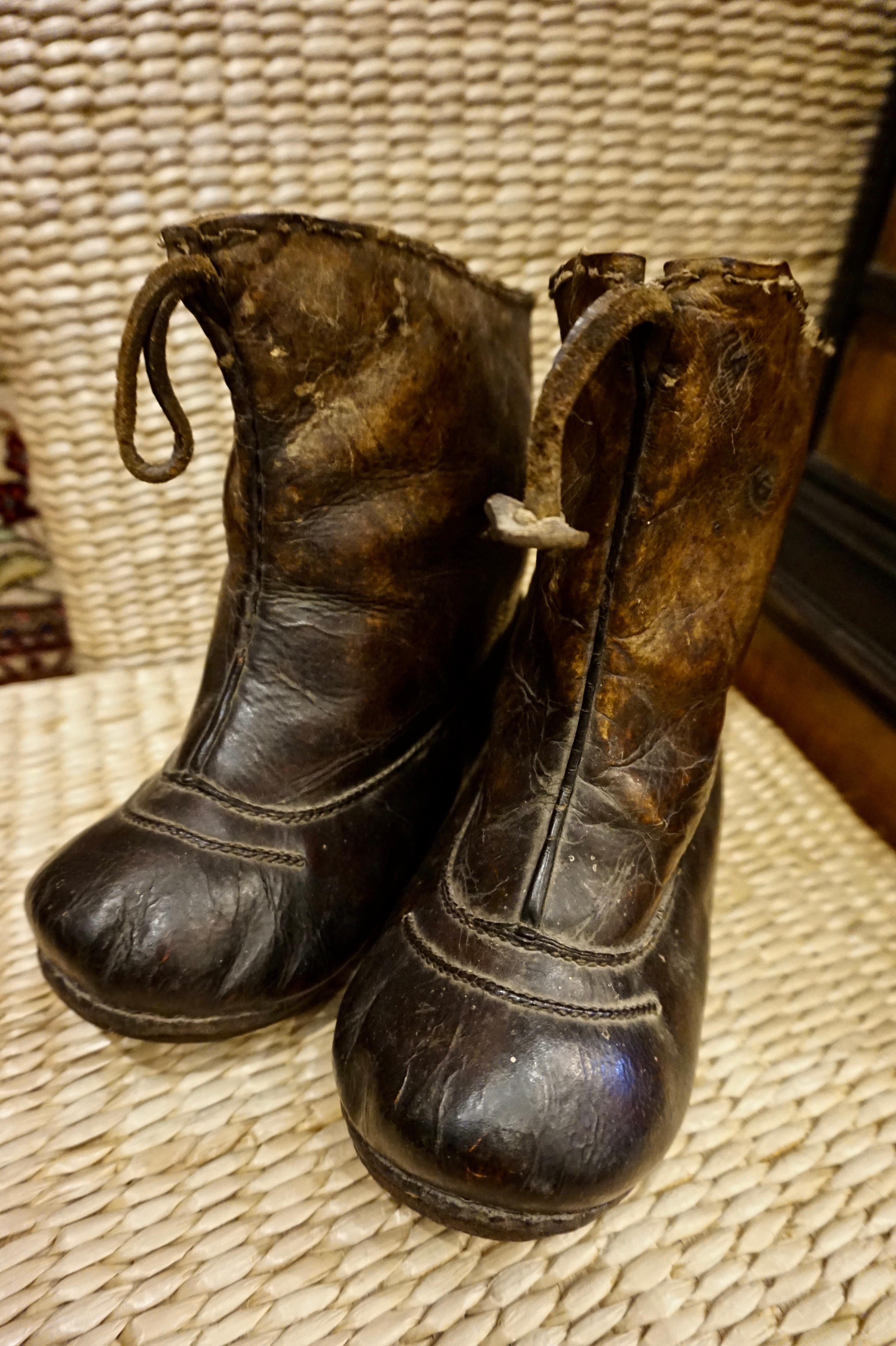 Very rare Asian handmade leather snow boots with metal studs. Unique conversation pieces that have stood the test of time and exude old world character. The leather has a wonderful patina and the old-world craftsmanship shines through from fine