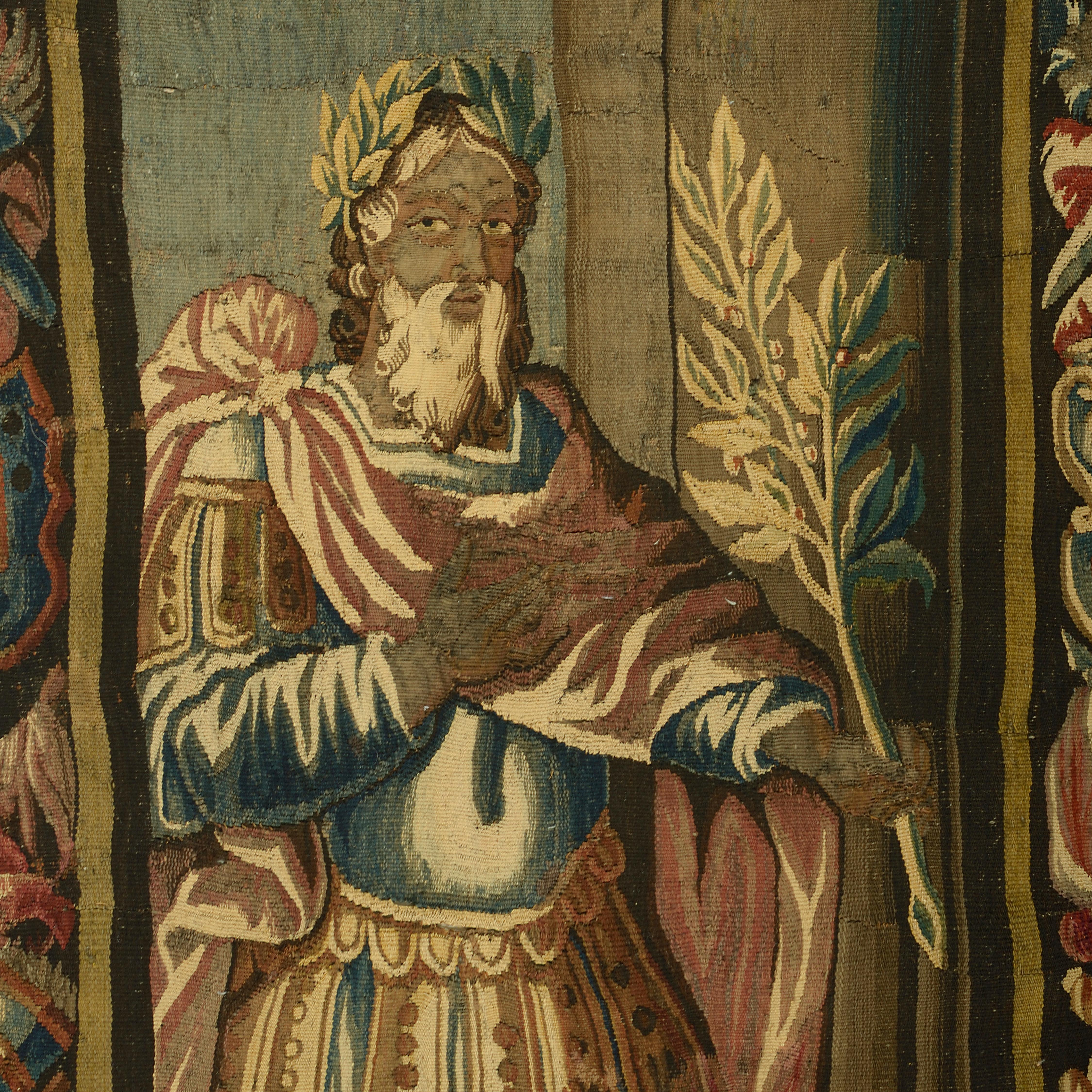 An 18th century portrait tapestry, depicting a Roman emperor wearing a laurel wreath, holding an olive branch, signed Manufacture Royal Aubusson.