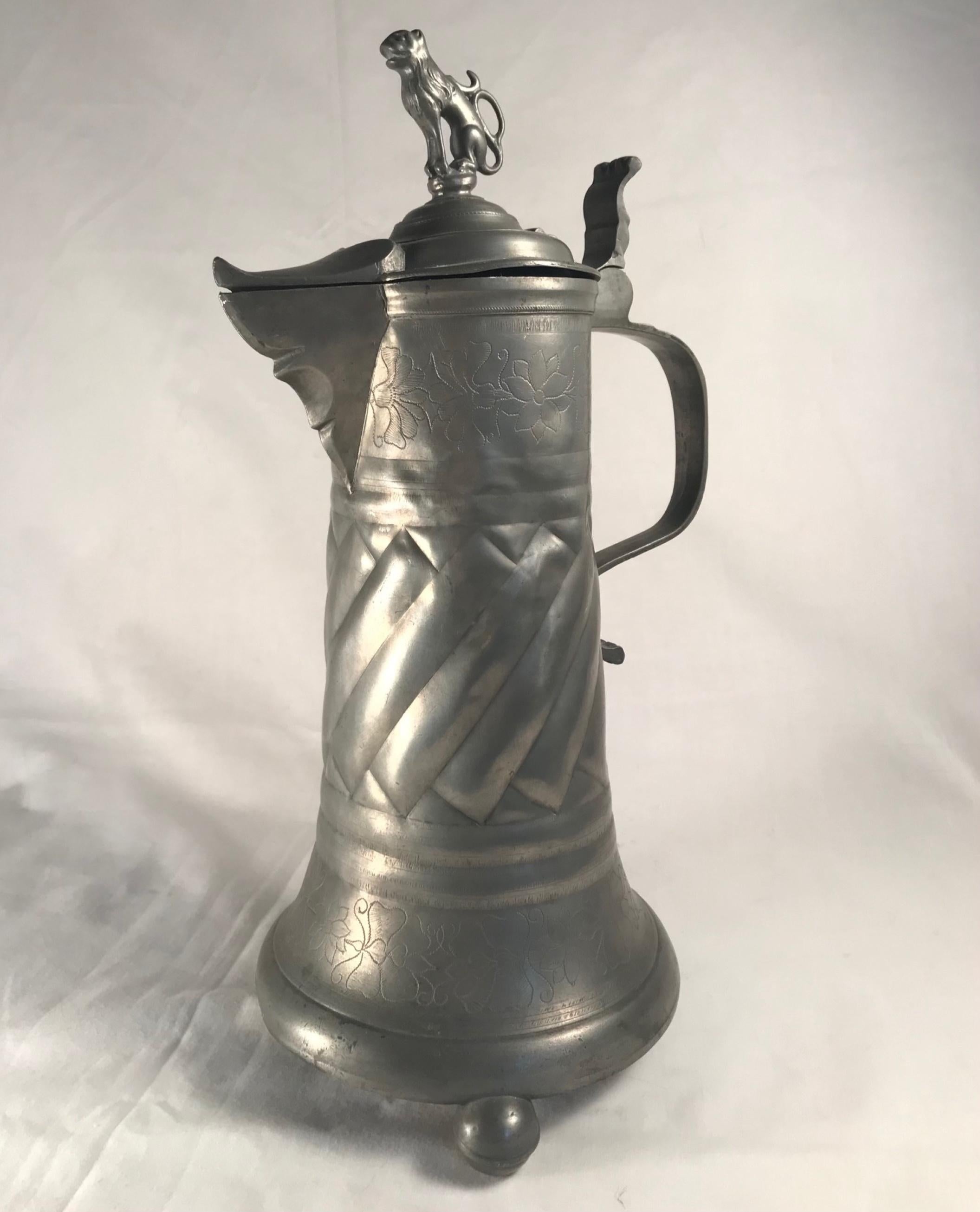 18th century Austrian-Hungarian pewter tankard hinged lion lid.

Fine antique Baroque pewter tankard with twist fluted sides and hinged lid topped with a lion figurine. The tankard is embellished with floral engravings. On the inside bottom a