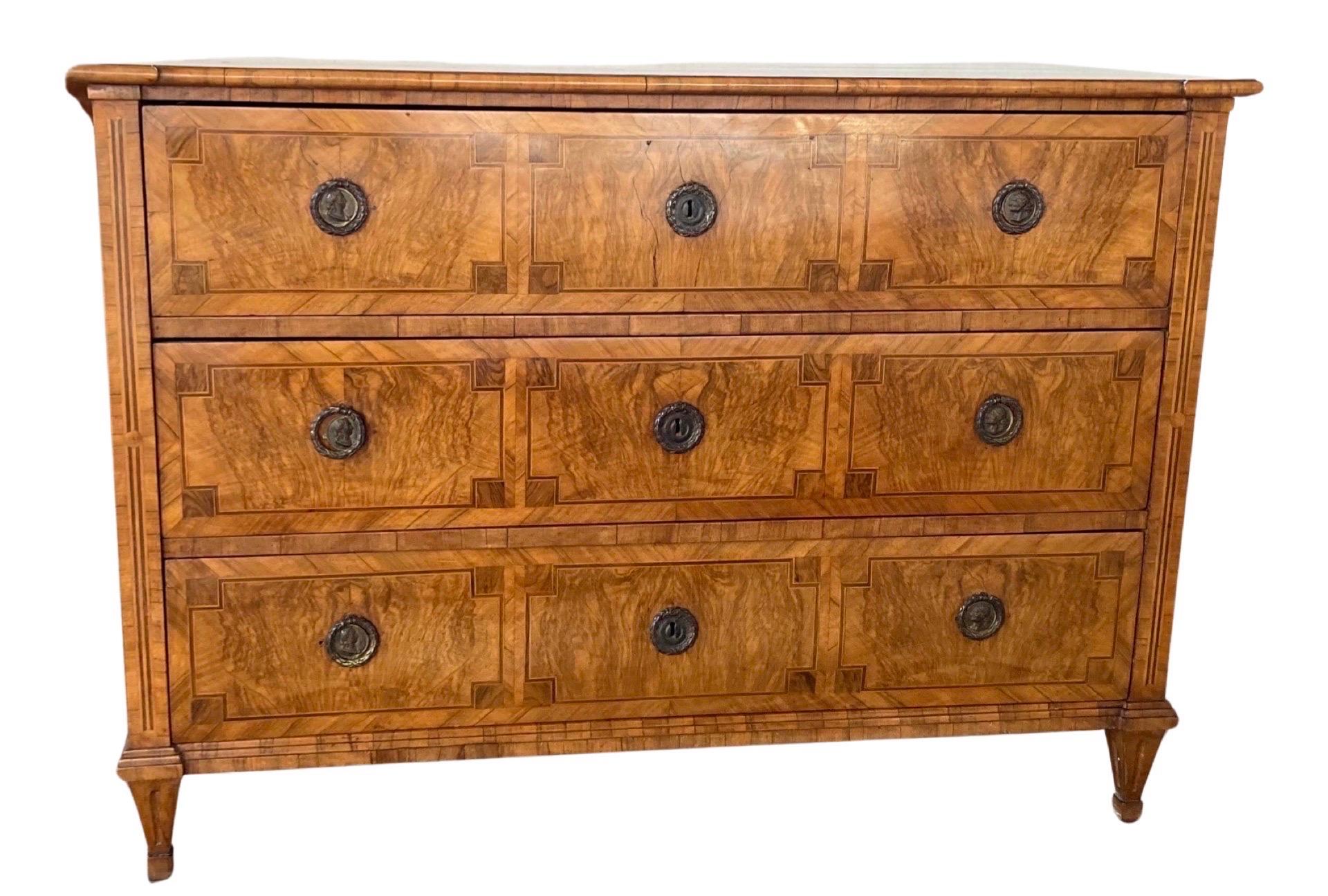 Commode hand-crafted in Austria or northern Italy in the late 1700s using walnut. The commode has very straight lines and features three inset drawers, all with hand-made dovetail joints and beautifully decorated drawer fronts. The drawers all work