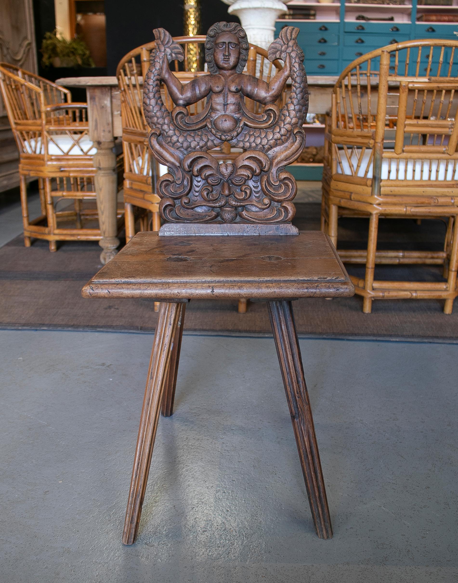 Antique 18th century Austrian walnut chair with 45cm tall handcarved merman relief backrest.


 