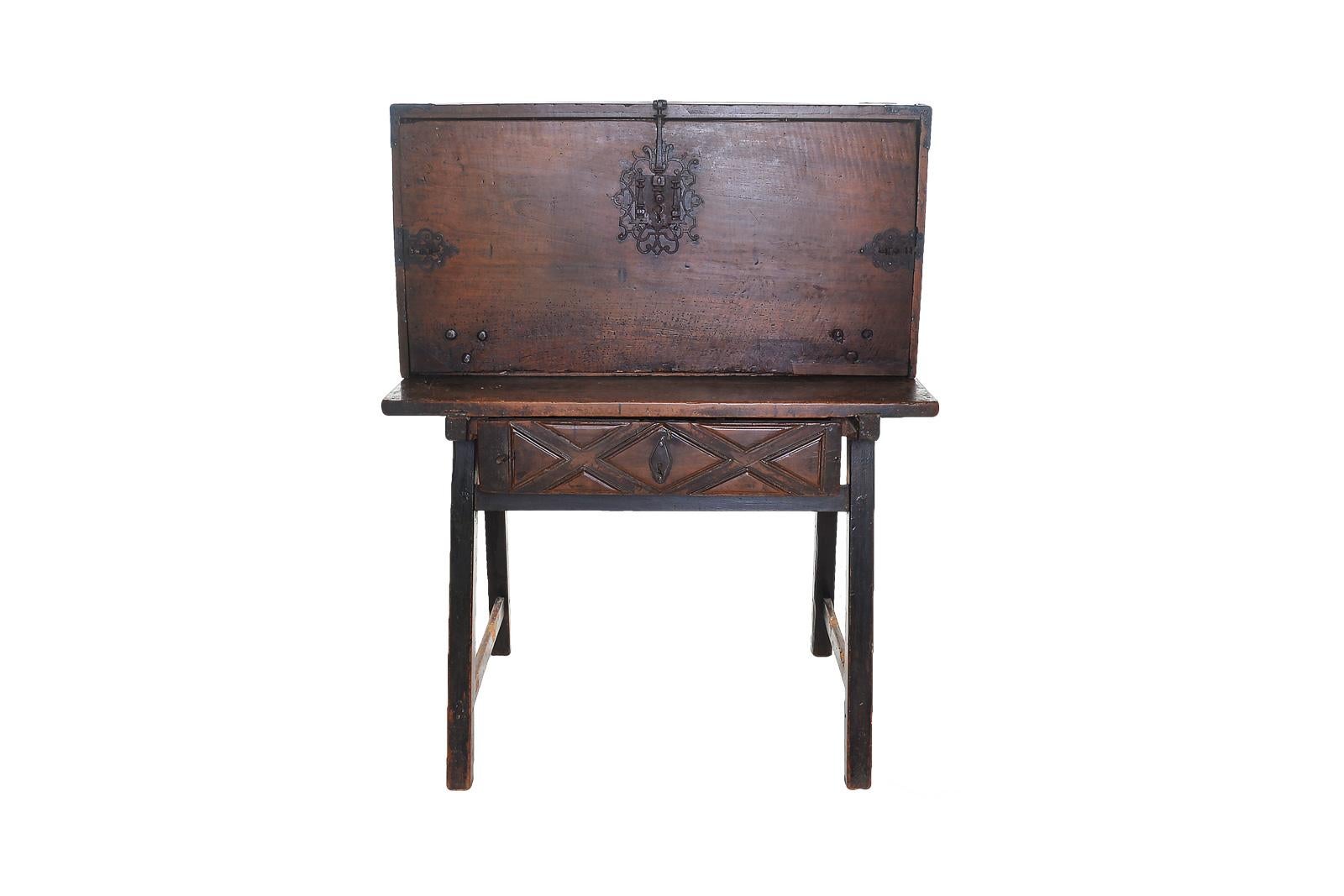 A bargueno is a spanish piece, it was like a traveling desk, opening with a flap revealing multiple drawers and doors.
Resting on a table opening with a drawer in the belt decorated wit diamond point. From the 18th century in molded walnut.
The