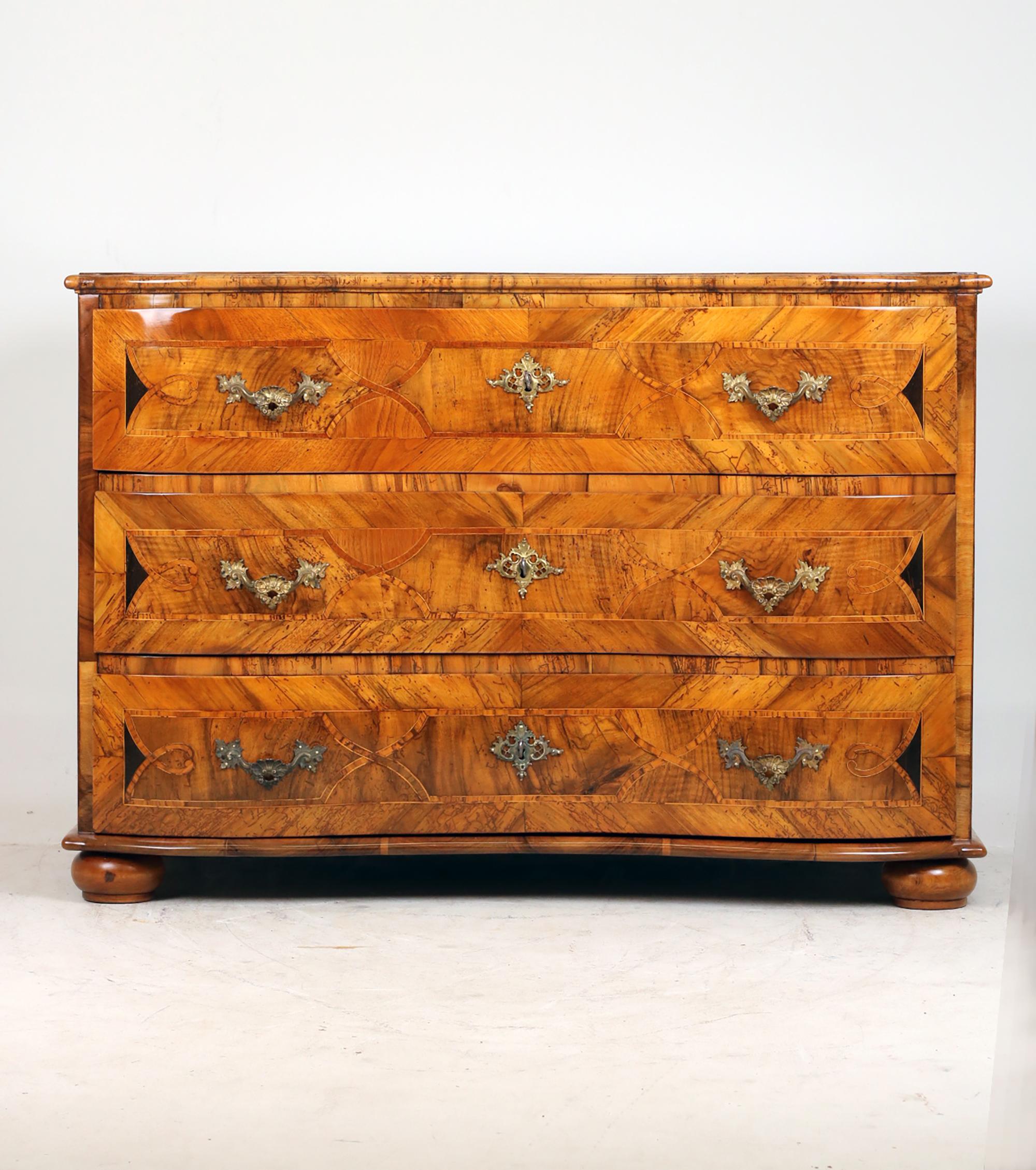 Baroque Chest of Drawers,
Ca. 1760 

Original chest of drawers veneered in walnut, very beautiful inlays in maple and plum, wonderful eye-catcher, 3 curved drawers inlaid, 3 compartments fielded, beautiful bandwork, original fittings, box locks, 3