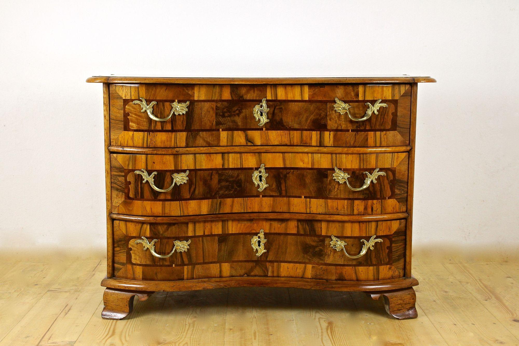 Extraordinary, rare baroque chest of drawers from the 18th century in South Germany. Elaborately made around 1760, this one of a kind Baroque commode impresses with amazing looking, beautifully nutwood surfaces and artfully crafted marquetry works.