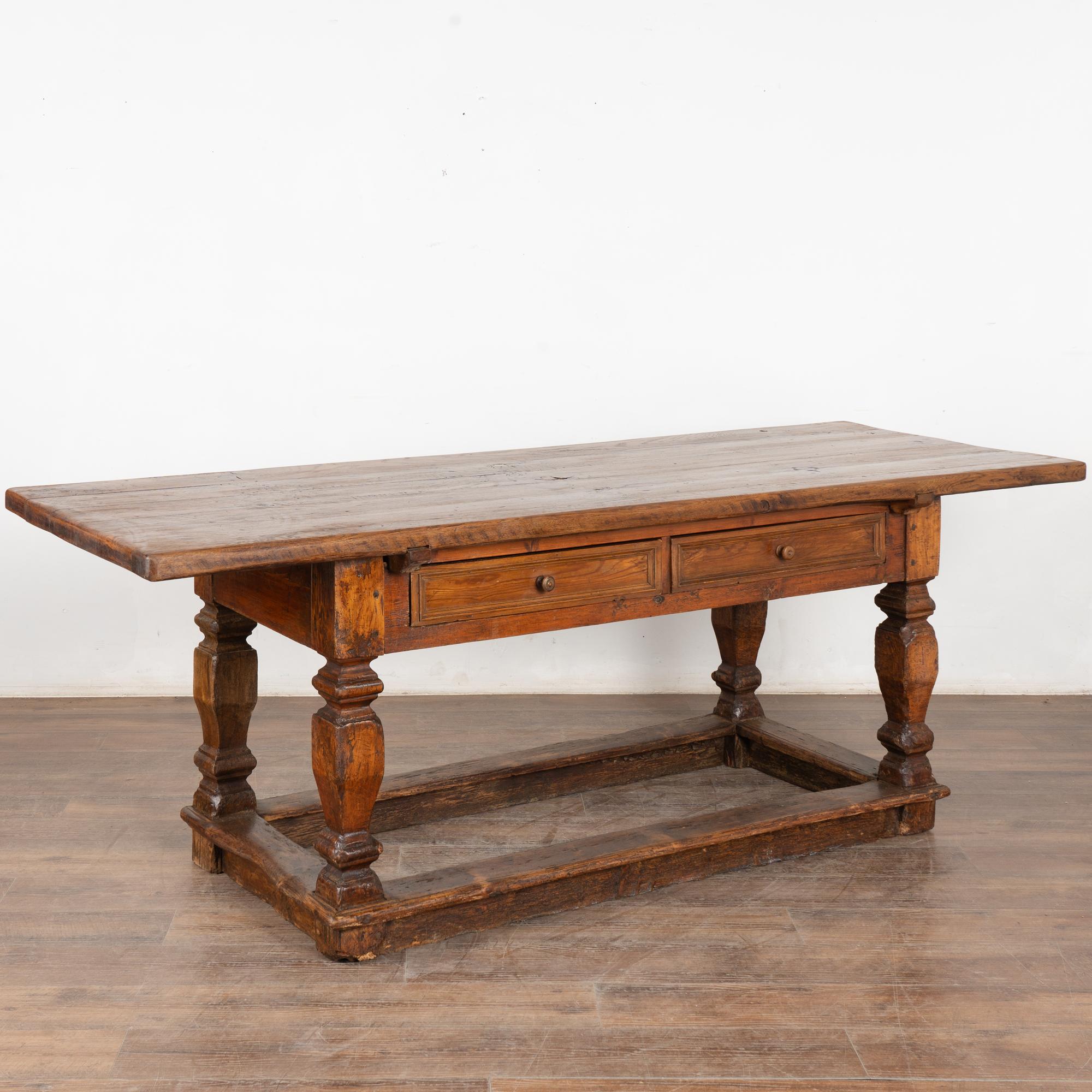 This handsome baroque oak library table with two functioning drawers has heavy turned legs and lower stretcher.
Restored, strong, stable and ready for use.
All scratches, cracks, dings, knarls in the top, and age related separation are reflective of