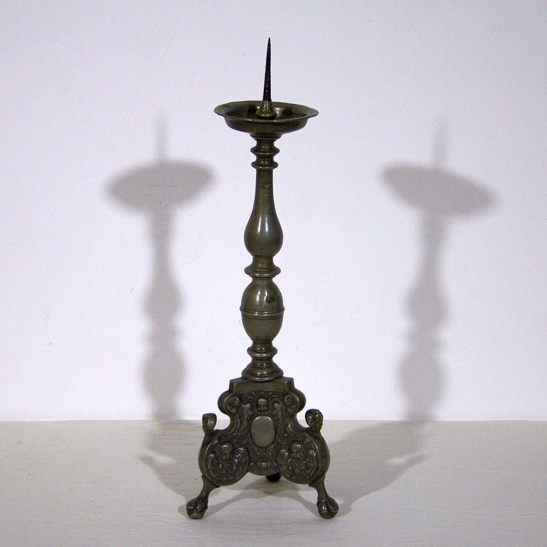 Beautiful and very rare pewter candlestick with angel heads, Germany, circa 1750. Weathered.