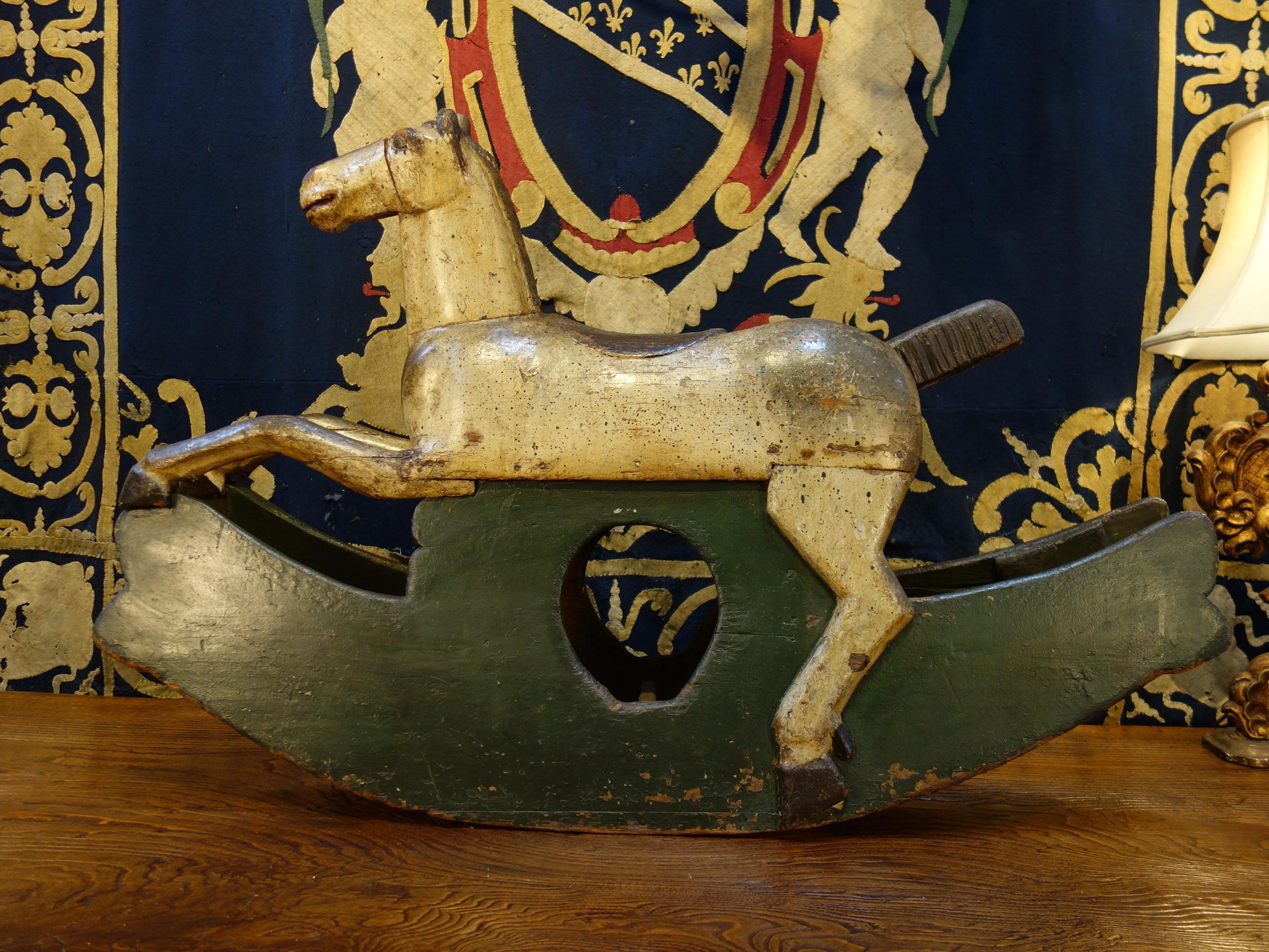 18th century Baroque style handcrafted rocking horse. Delightful simplicity in carved and painted wood, circa 1760.

Measures: 48” L x 13” D x 31” H.