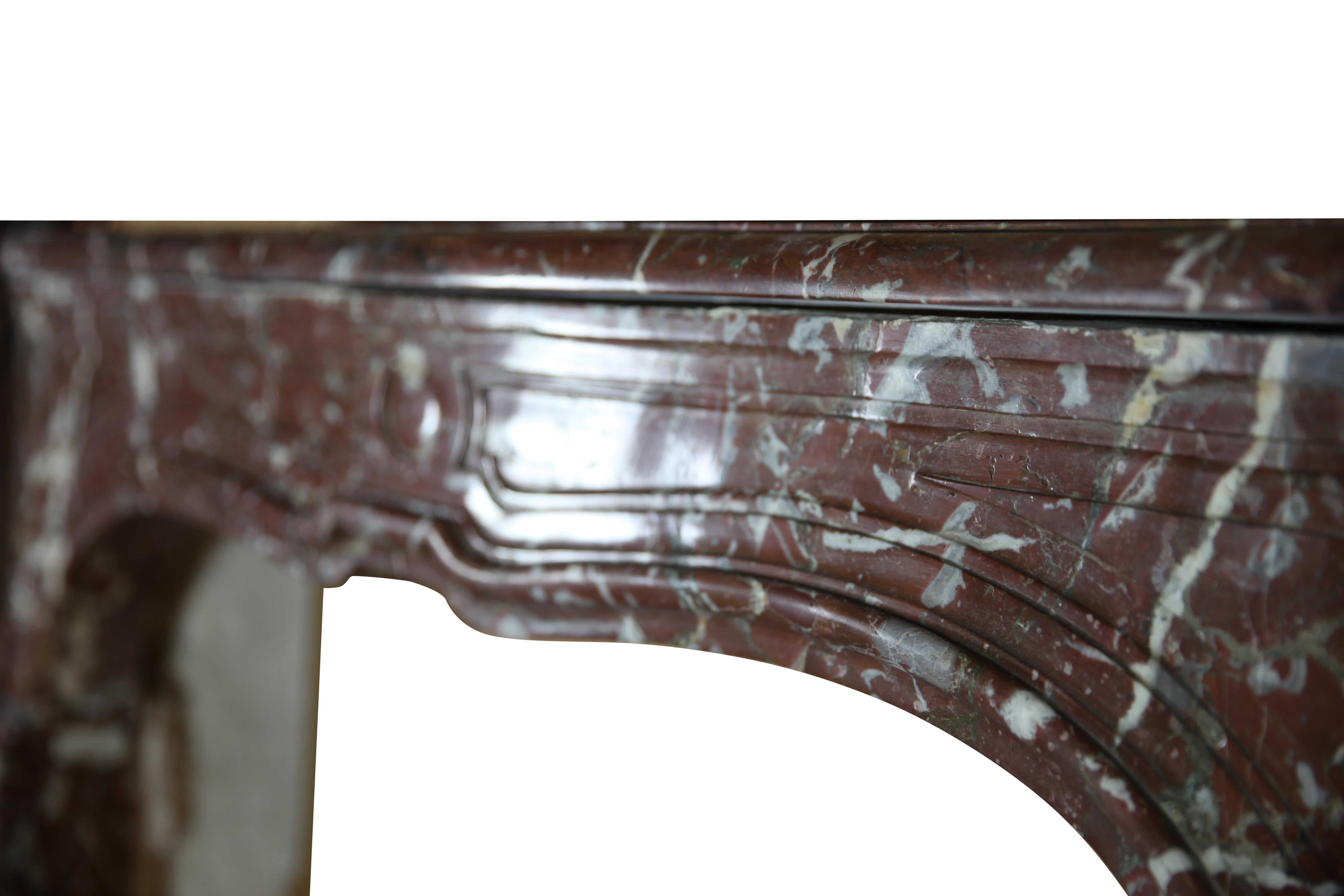 This 18th-century fireplace surround from Ghent, Belgium, is a striking example of Louis XIV style craftsmanship. Made from brown antique Belgian marble, the surround exudes both warmth and grandeur.
The marble features a deep brown color,