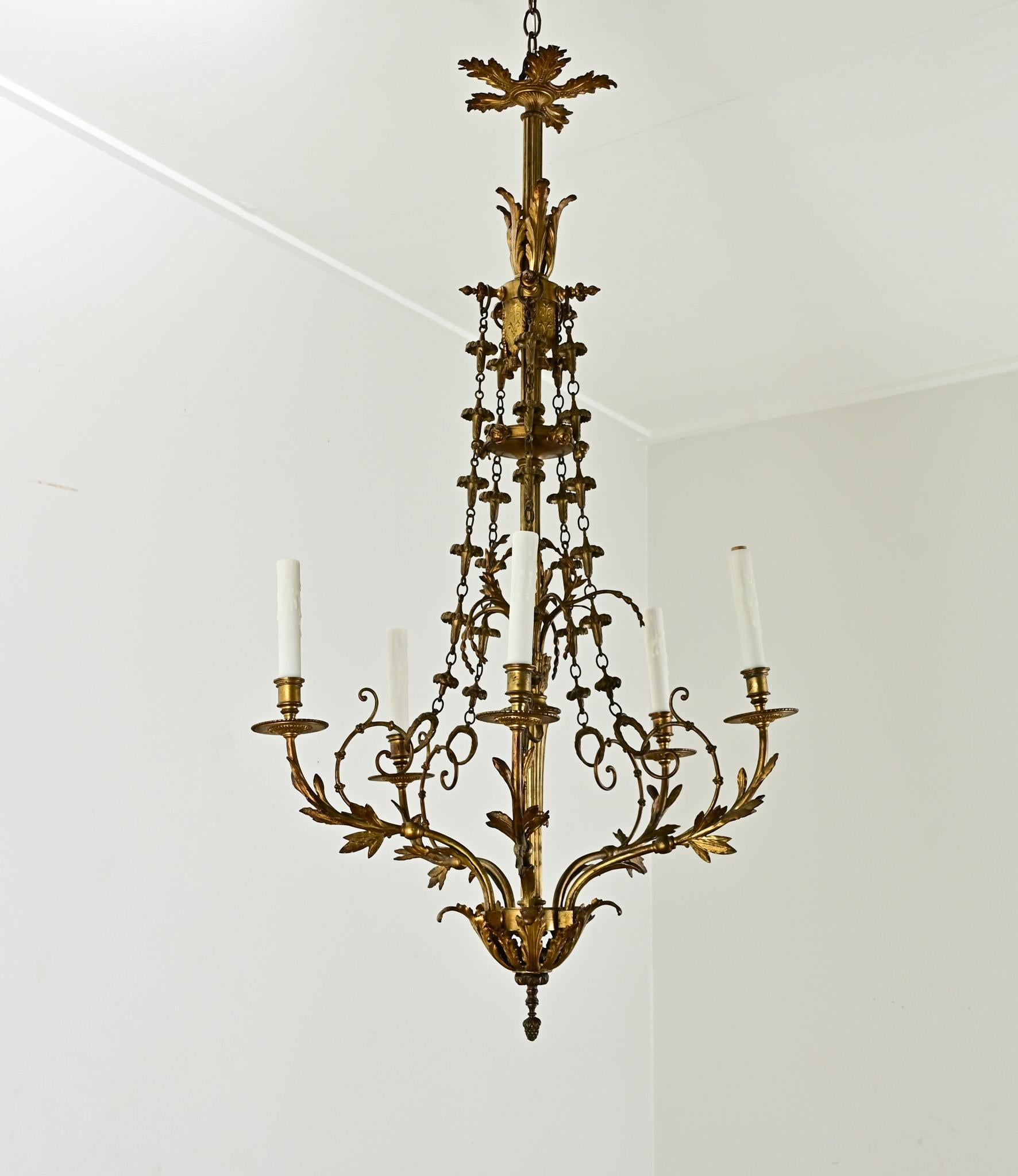 Slender and elegant, this Louis XVI-style chandelier from Belgium will add instant panache to your room. Cleaned and wired for US electrical using UL-listed parts and is ready to hang in your interior. Six candelabra bulbs illuminate the