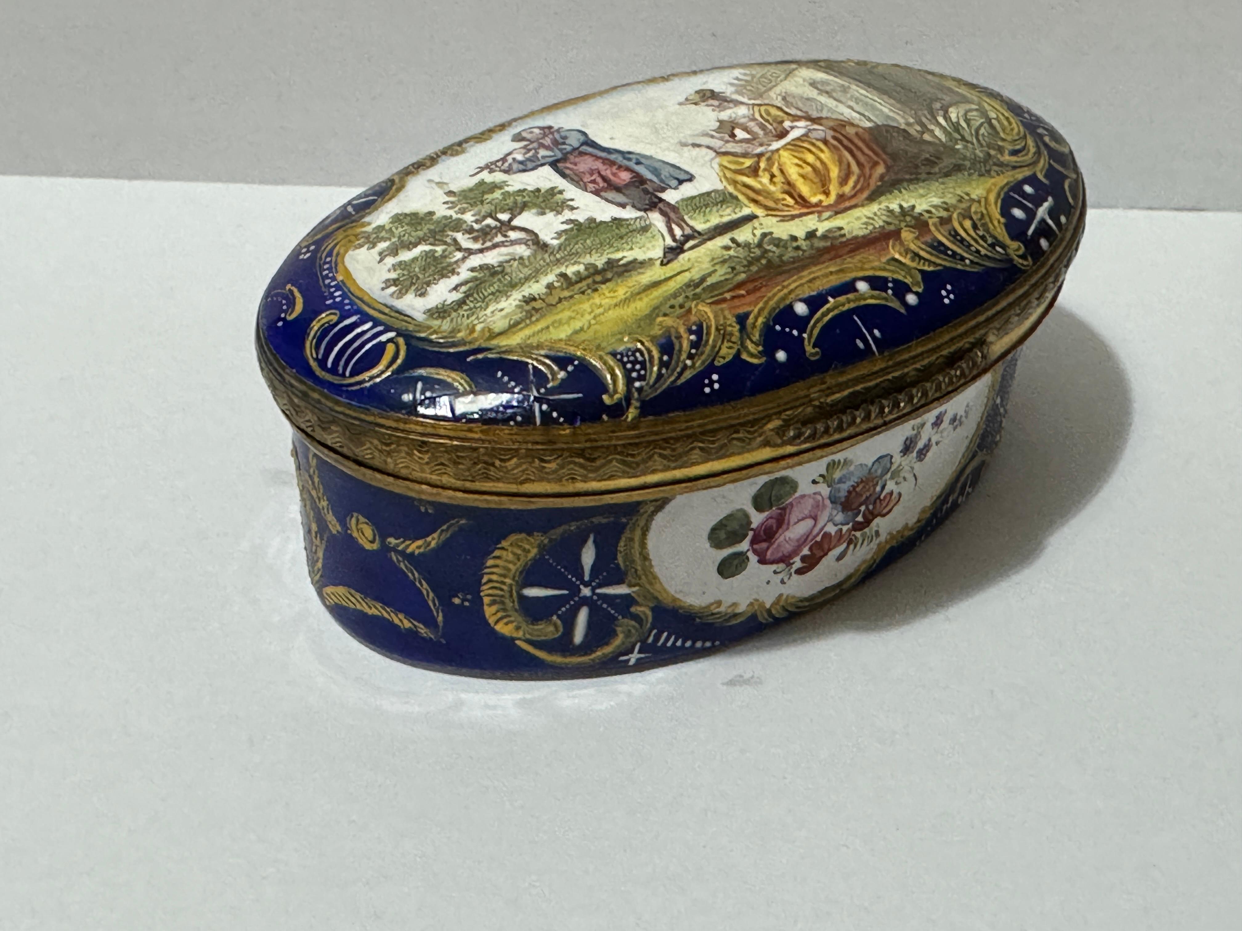 18th Century Bilston Enamel Oval Patch / Snuff Box Circa 1780, blue-ground, transfer printed and painted with a flautist and a lady singer in a garden. 

35mm high x 90mm wide x 65mm depth     