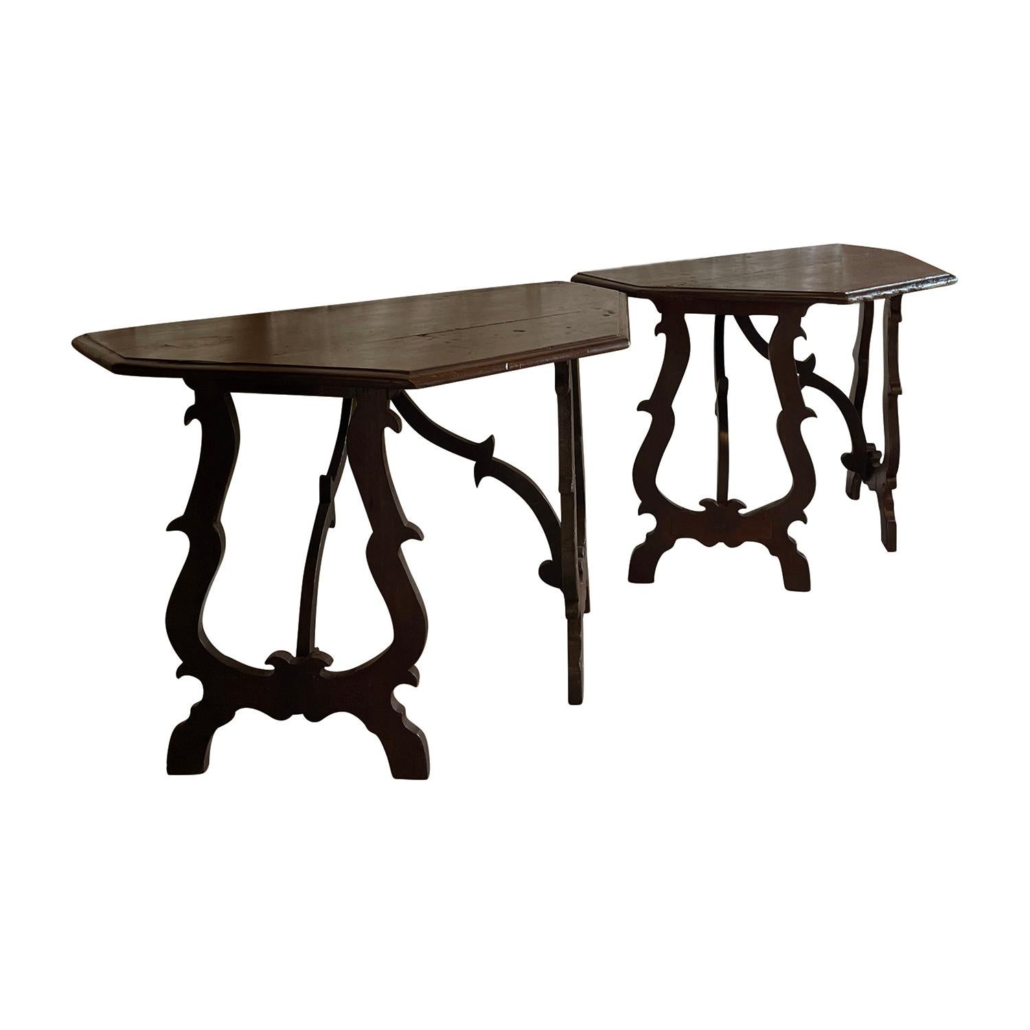 Superbe paire de tables baroques toscanes du XVIIIe siècle en bois de noyer ciré foncé, en bon état. Ces consoles italiennes autoportantes de type demilune ont un design élaboré. Les plateaux arrondis en demi-lune ont des bords moulés et sont