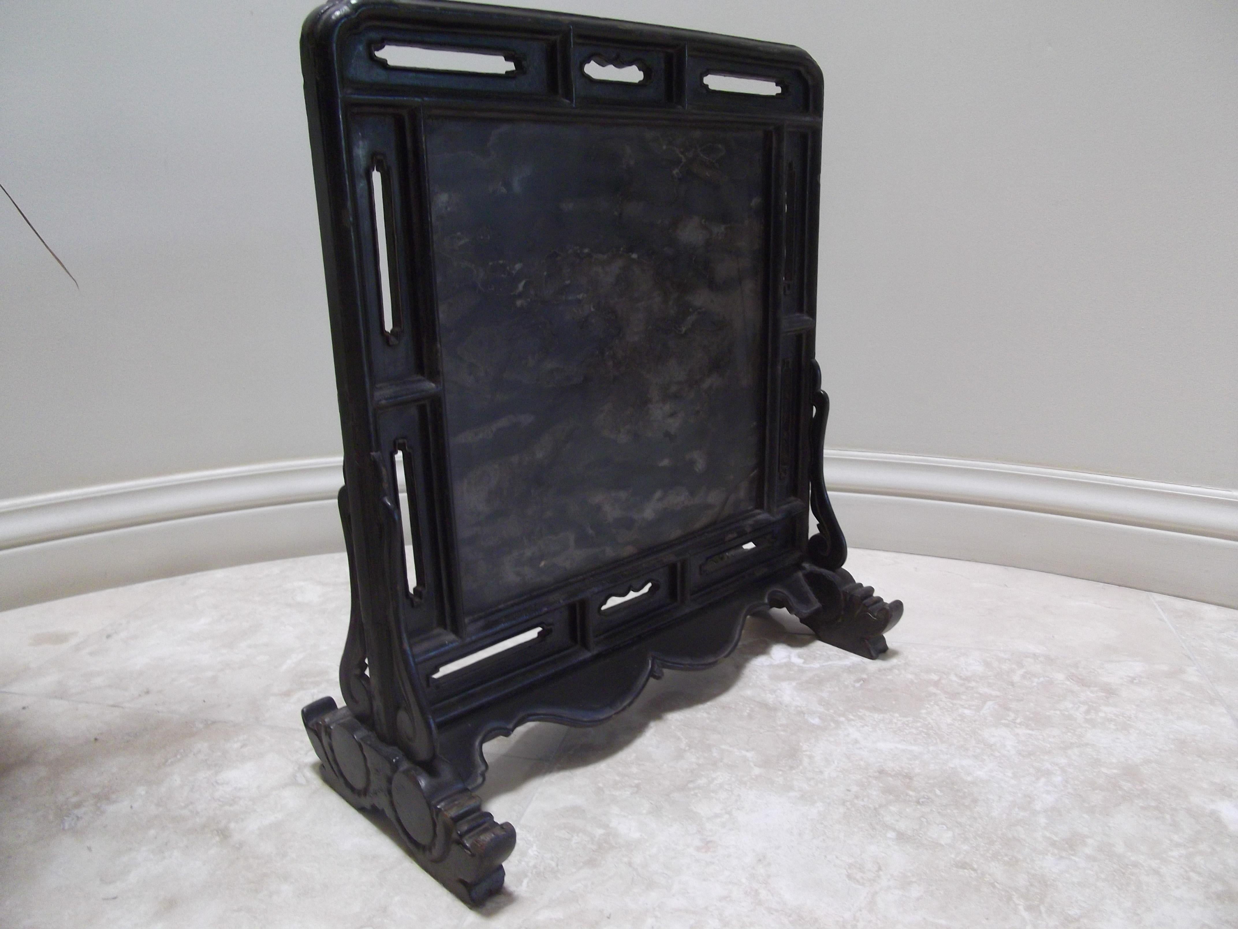 Black Lacquer Table Screen	24h x 21.5w x 1.5d
This particular table screen is of the multi-panel construction style which is found in a lot of the earlier cabinets coming out from Shanxi.  The mitered struts connecting the different parts have sharp