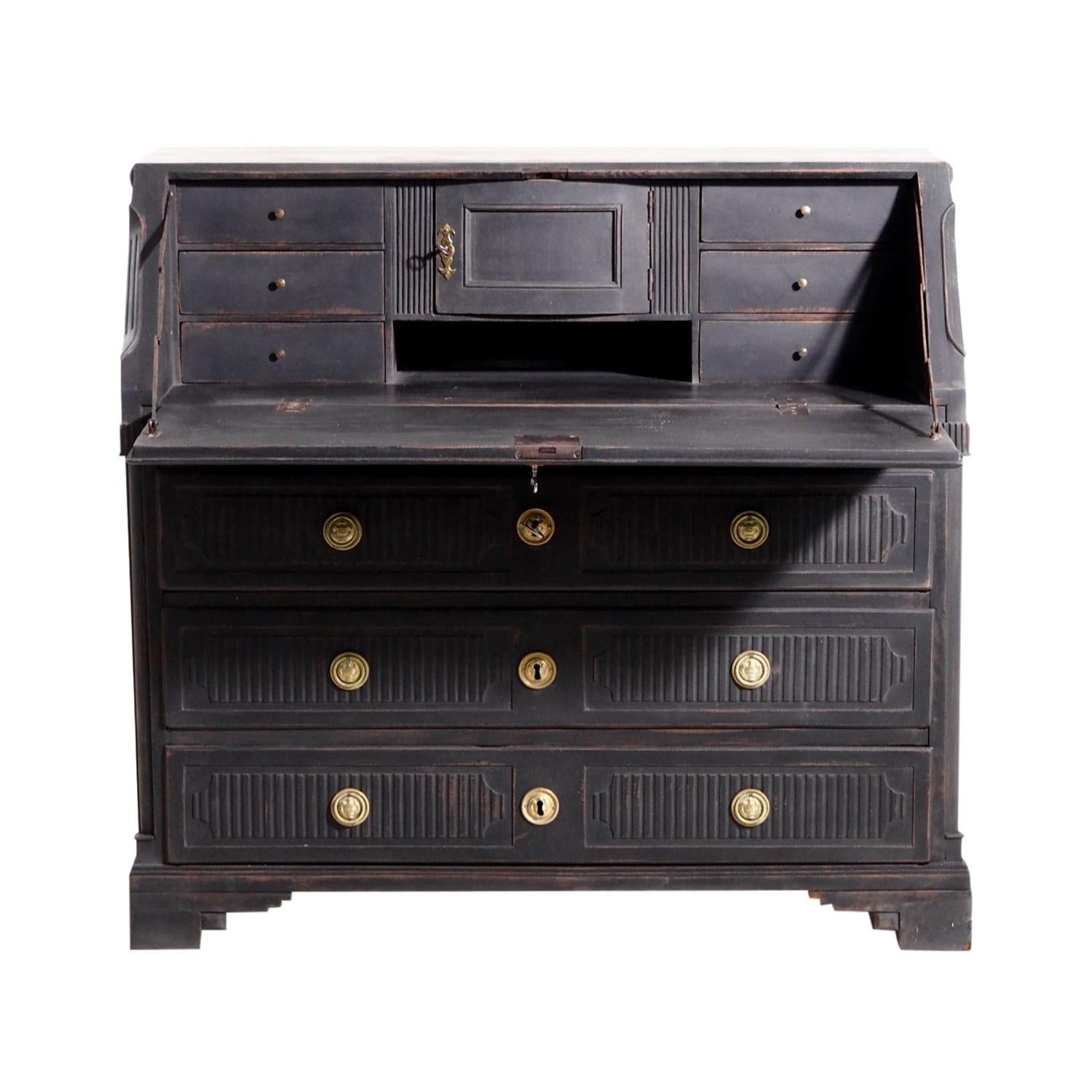 An antique Swedish Gustavian bureau made of hand crafted painted Oakwood, in good condition. The Scandinavian writing table, desk features many small storage drawers within and three large storage drawers. The black, drop front secretaire represents