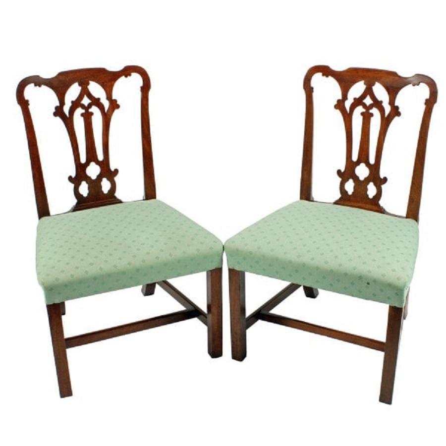 A pair of 18th century Georgian black walnut chairs.

The chairs have broad seats and back with a shaped top rail and pierced central splat.

The legs are square and joined by a 'H' cross stretcher, the back legs kick out.

The chairs have a