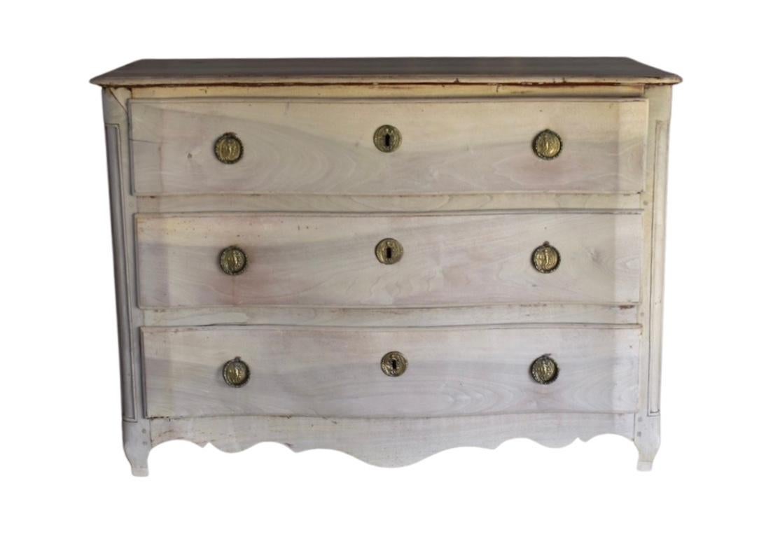 Beautiful large commode made in France in the mid 1700s using walnut and pegged construction. The commode features three large drawers showing beautiful hand-made dovetails. The chest is decorated by carvings on the rounded corner of the case,