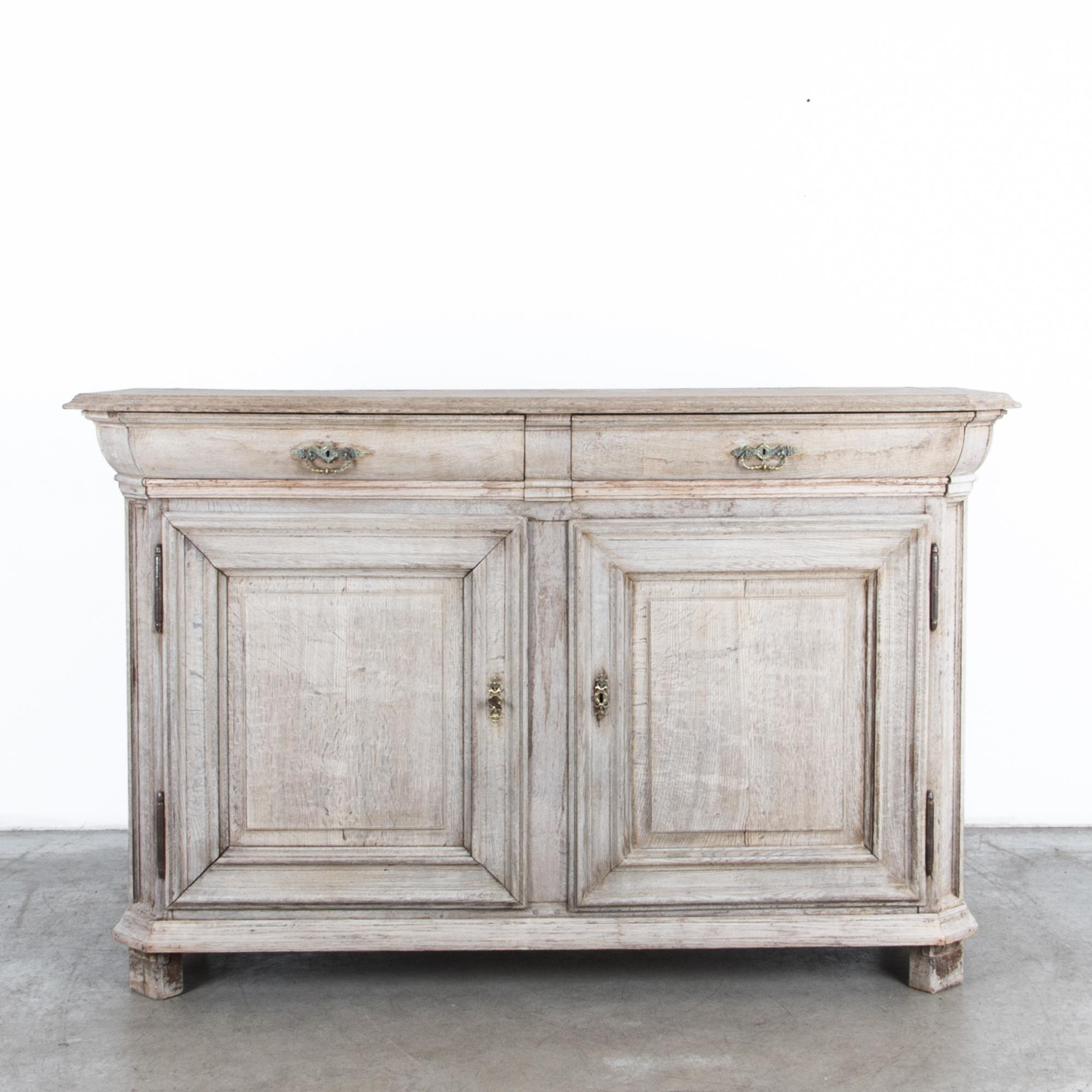 A Flemish style cabinet from Belgium, circa 1780. Beautiful proportions, quality material, and detailed construction, are transformed by time. A rustic finish has been restored in our atelier complimenting the natural textured figure of the wood.