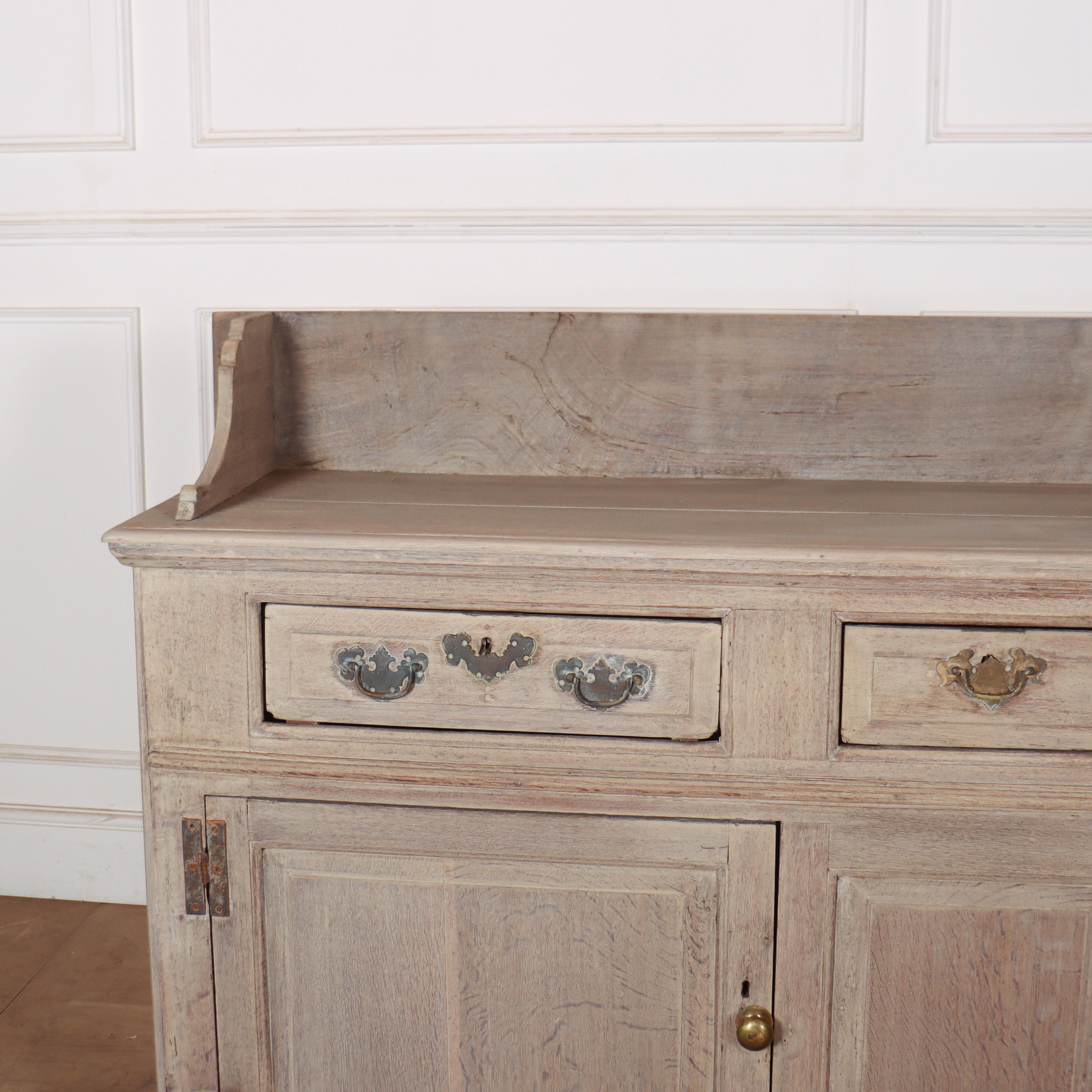 18th C English bleached oak dresser base with a tray back. 1760.

Height to worktop is 35