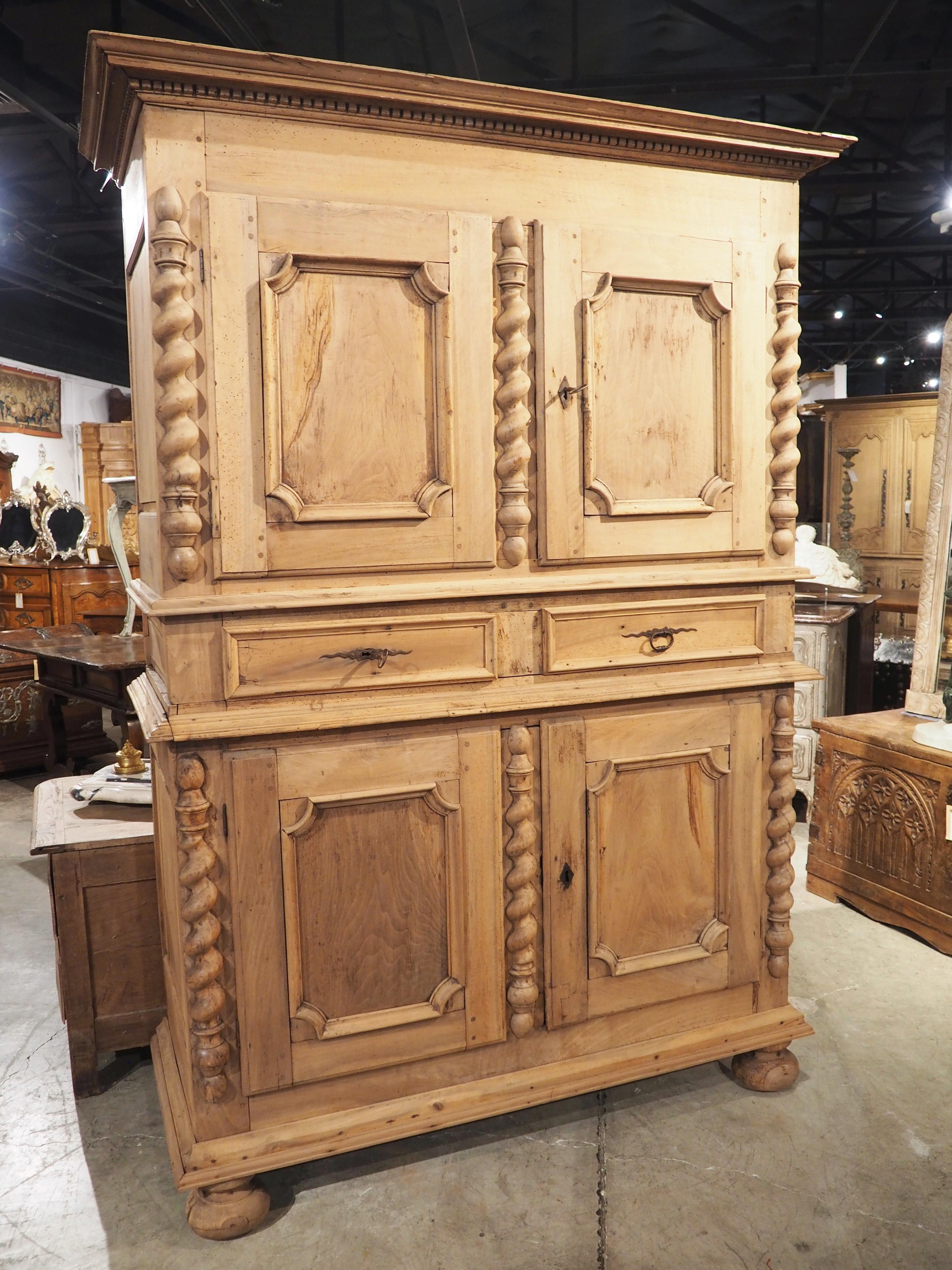 When antique furniture is bleached, such as this 18th century walnut four door buffet from Lyon, France, it allows the wood grain and carved elements to become focal points. Notice the thick moldings above and below the doors, as well as the turned