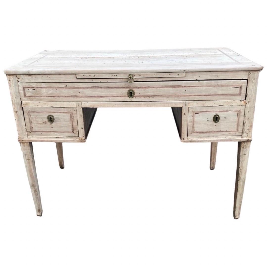 Writing desk handmade in Italy in the late 1700s using walnut and pegged construction. This is a gorgeous desk with very straight lines and simple veneer that does, however, Stand out in a crowd because of its gorgeous ivory color with pinkish
