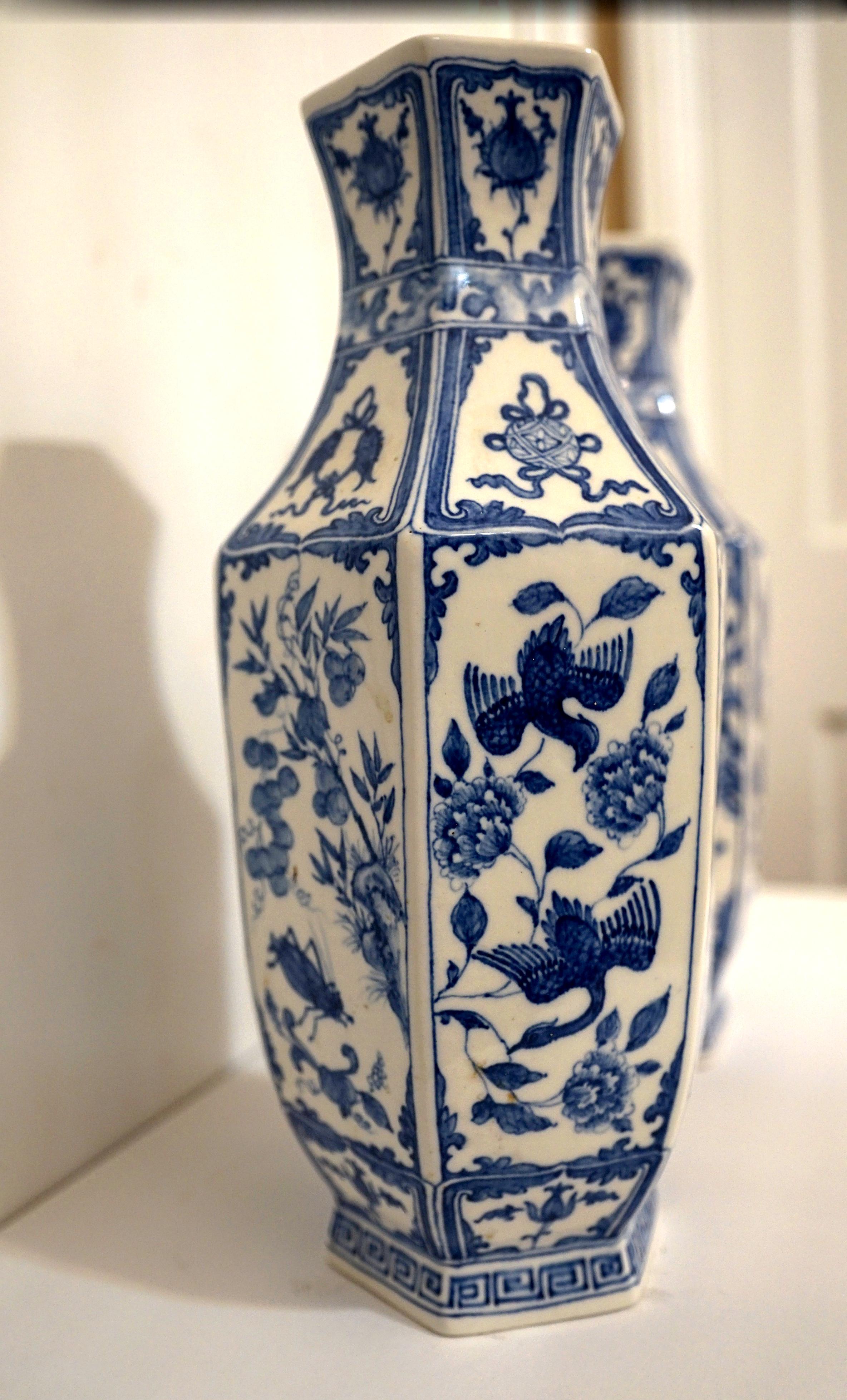 This pair of Continental Chinese influenced late 18th / early 19th century vases are a great auction find. I could not believe my eyes at the pair!
They are blue and white hexagonal porcelain urns In the style of Delft. The white hexagonal body is