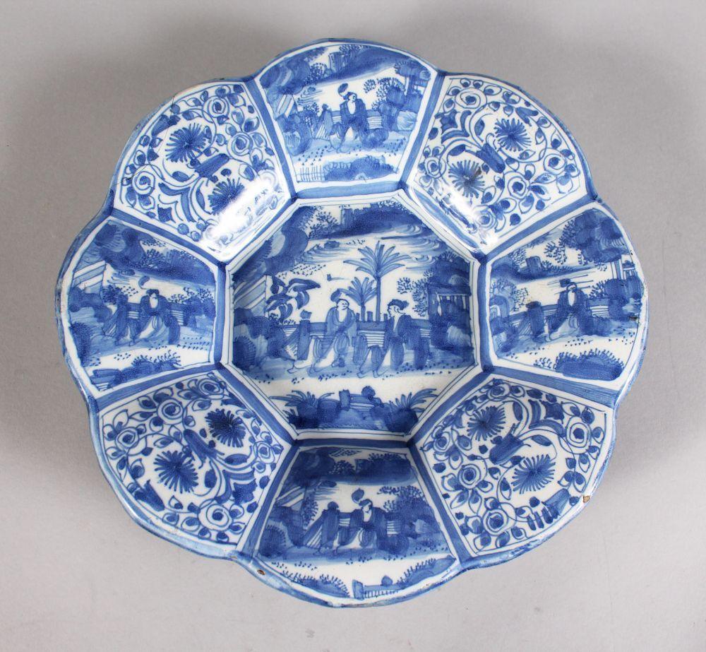 Thelobed octagonal form, with central chinoiserie scene, the border with stylised foliage panels alternating with further chinoiserie scenes.
