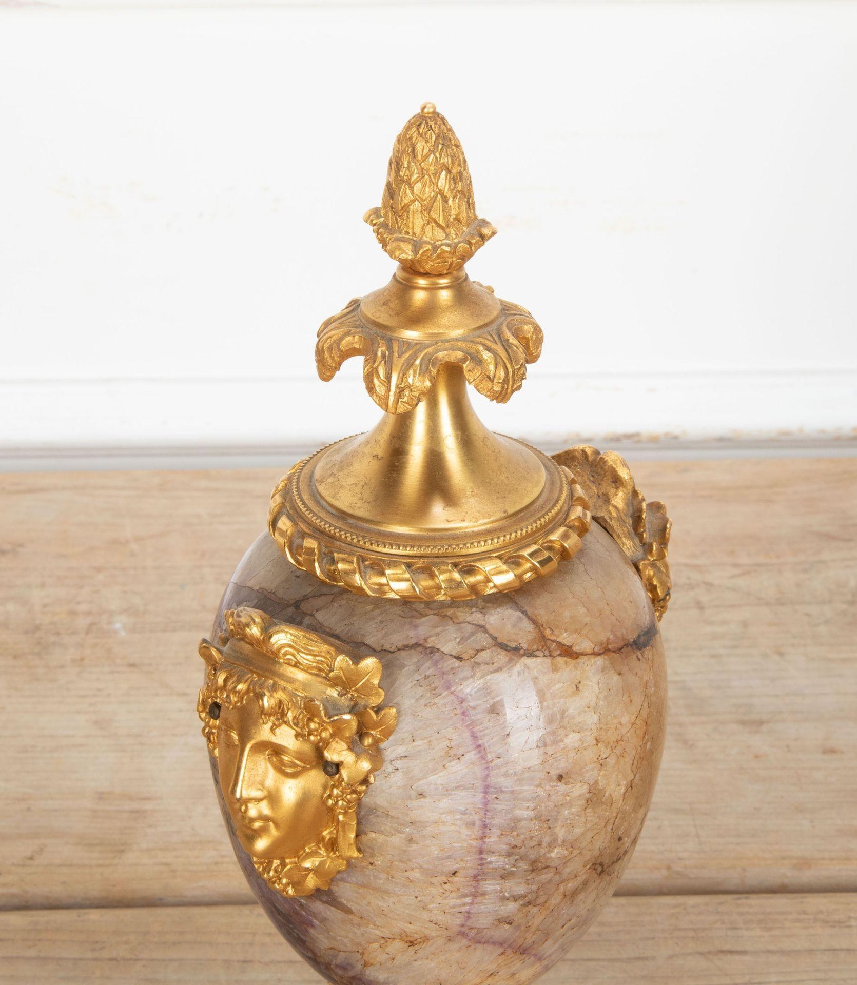 A wonderful late 18th Century ormolu mounted Blue John urn, attributed to the workshop of Matthew Boulton.
The acorn finial with rope twist border, above pale veining and rich purple marble, with bold female masks to the sides, over palmette apron
