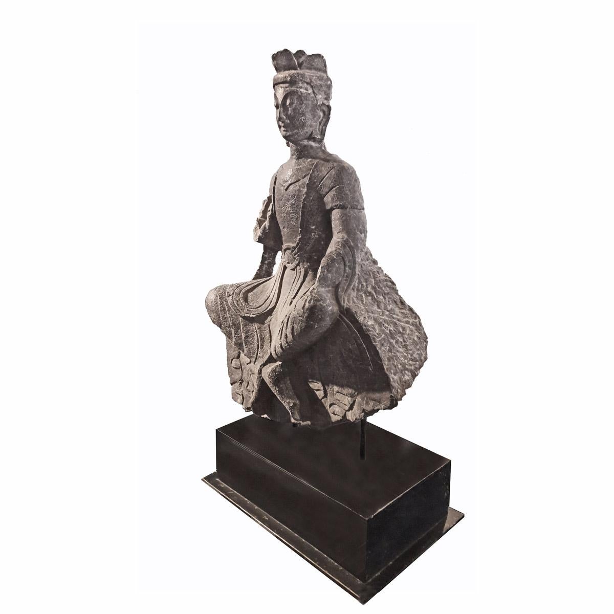 An antique statue of a Bodhisattva, Sanskrit term for one who, motivated by great compassion, demonstrates spontaneous desire to achieve Buddhahood (awakening). This 18th century Chinese sculpture of a Bodhisattva, circa 1760, is carved out of solid