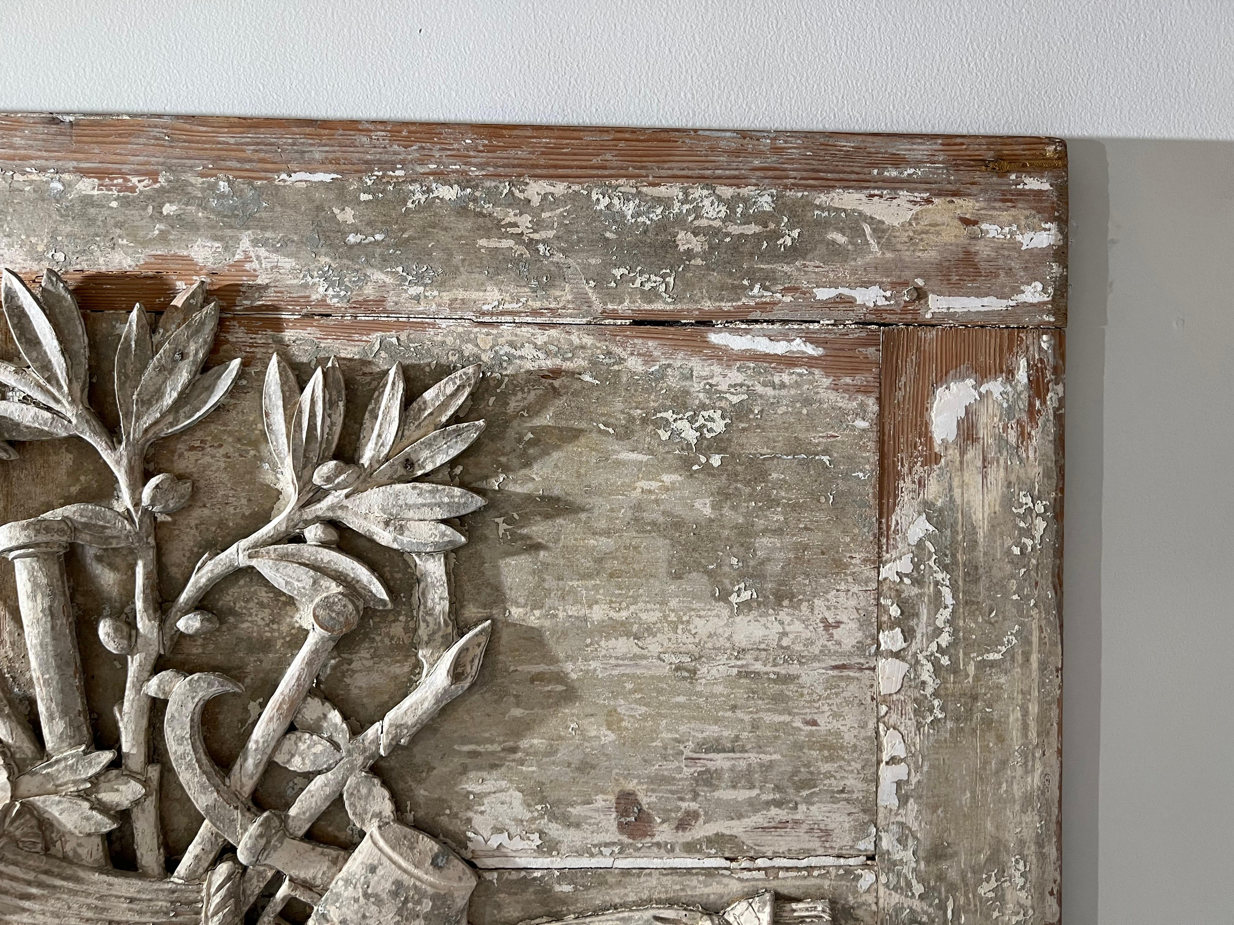 Most likely a fragment from boiserie of period paneling. Presents very well and shows great age.

The hand carved panel depicts a garden theme. Tools, Flower Basket, Plants and a vine.

