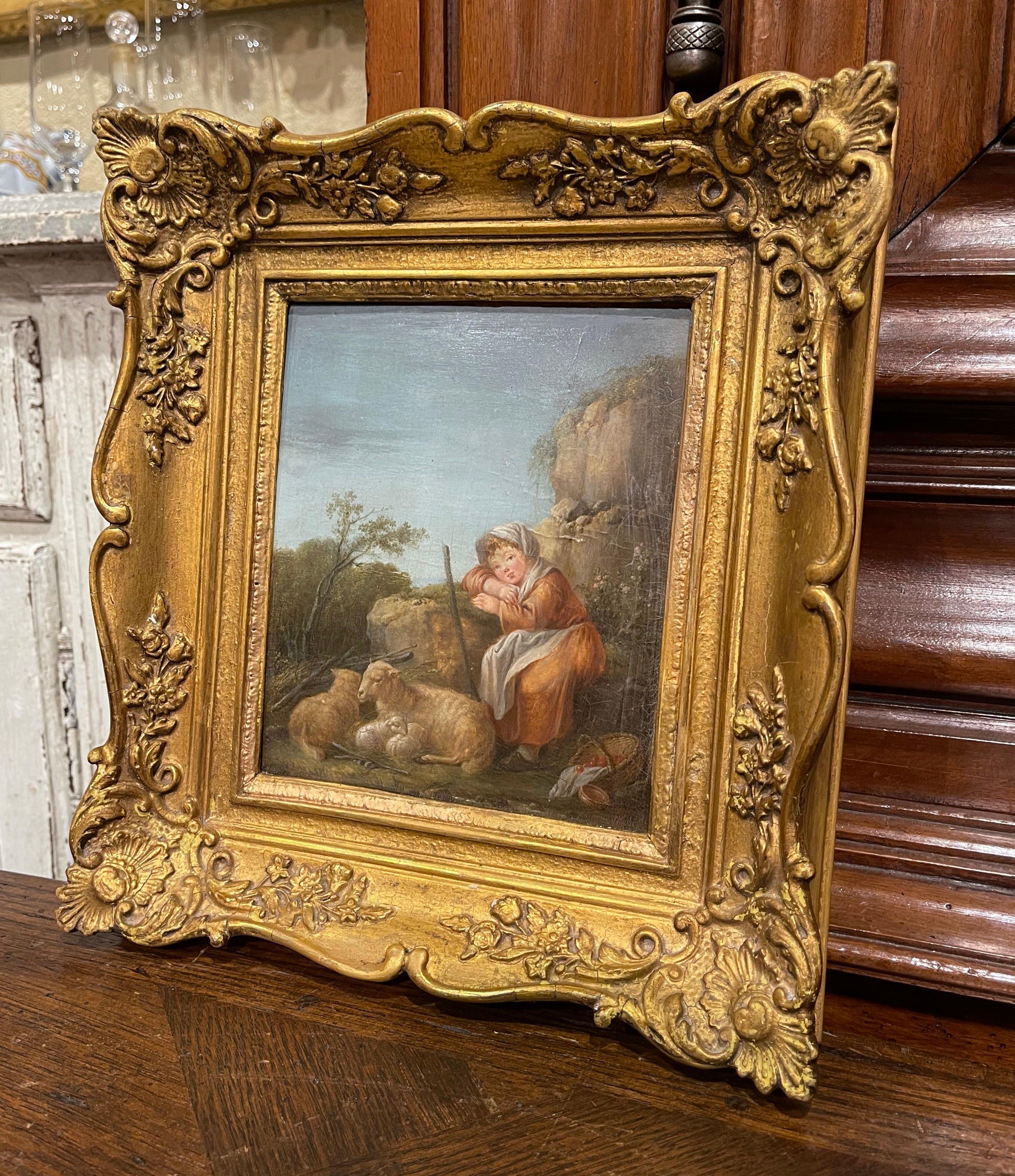 Created in England and attributed to Francis Wheatley (1747-1801), the oil on panel depicts a young shepherdess attending her sheep and lambs in a pastoral landscape. The colorful art work is dressed in the original carved gilt wood frame. It is