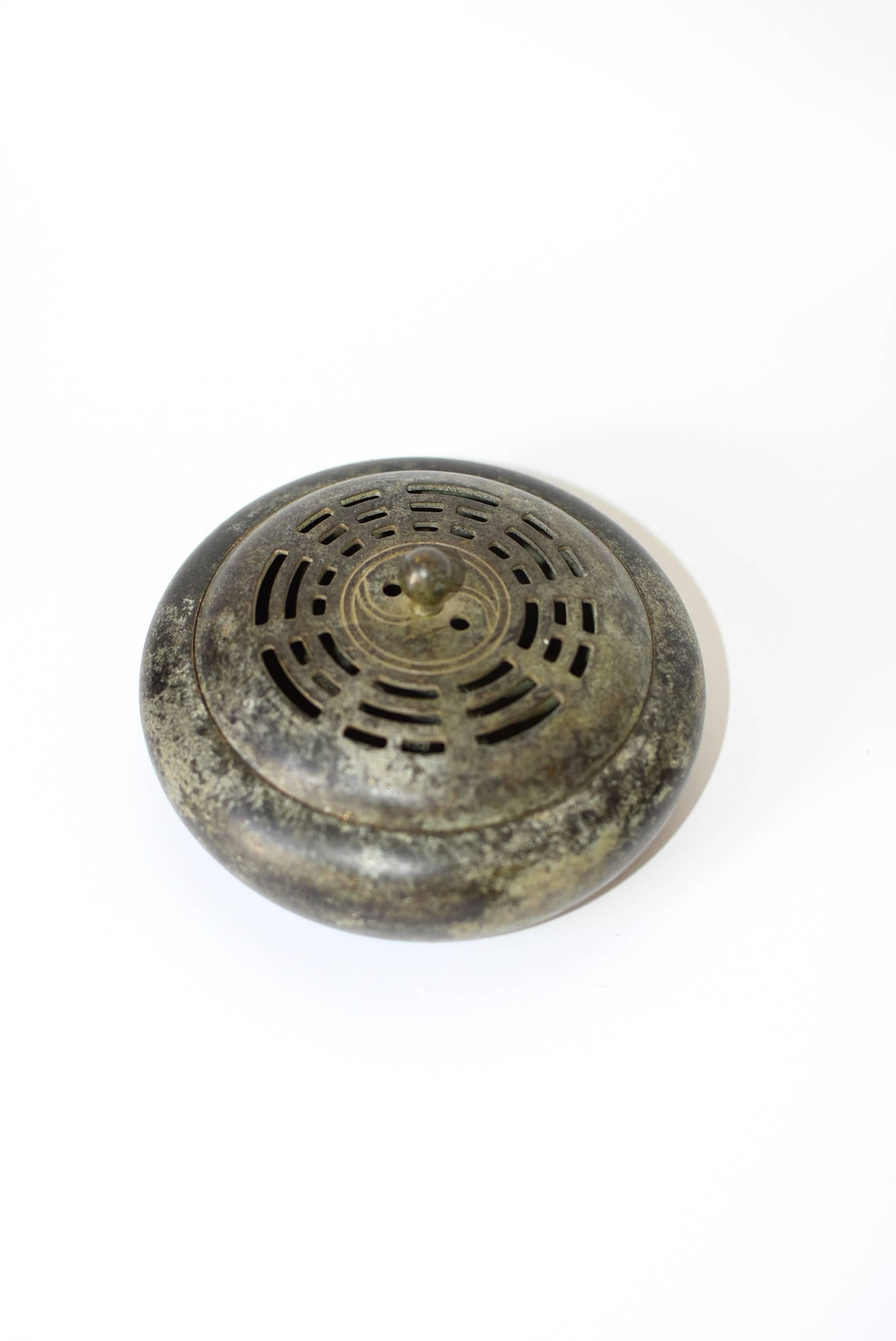 Exquisite Qin dynasty incense burner features the coveted Ba-Gua Yin Yan Zen pattern. Such a design is believed to harmonize air and balance energy. Used in an incense burner, the smoke is guided out of the burner through the slots that formed the