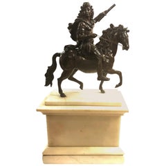An 18th Century Bronze Equestrian Group of Louis XIV on Horseback