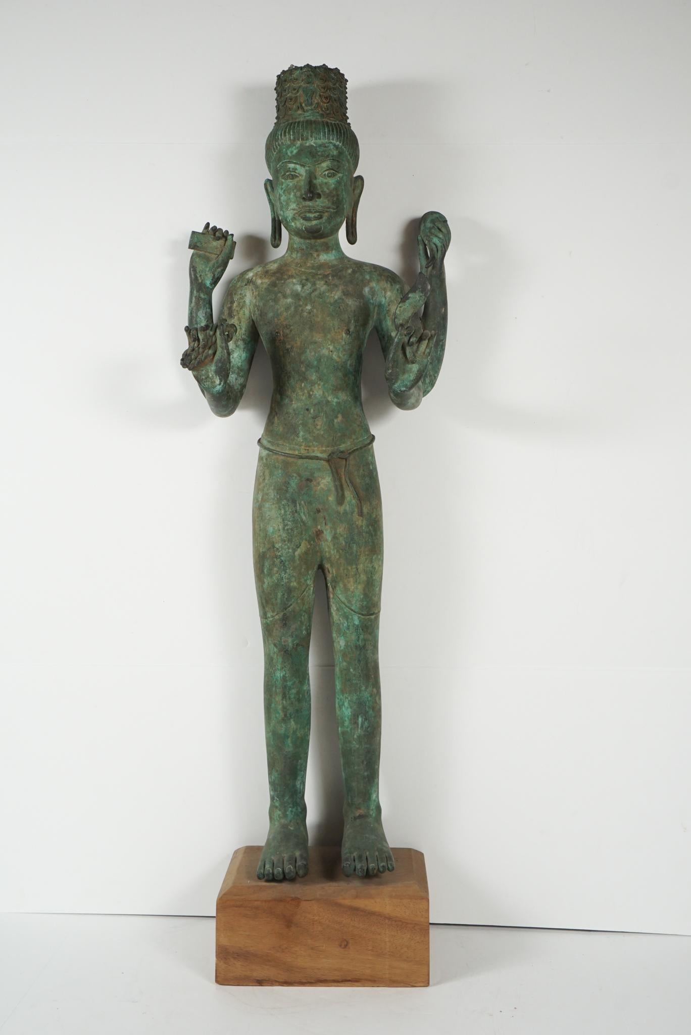 This tall and dramatic figure is finely cast and represents the best in Khmer bronze casting from Cambodia and Northeast Thailand. Associated with Hindu and Buddist worship and royal cult practices, this figure of the Bodhisattva is most likely a