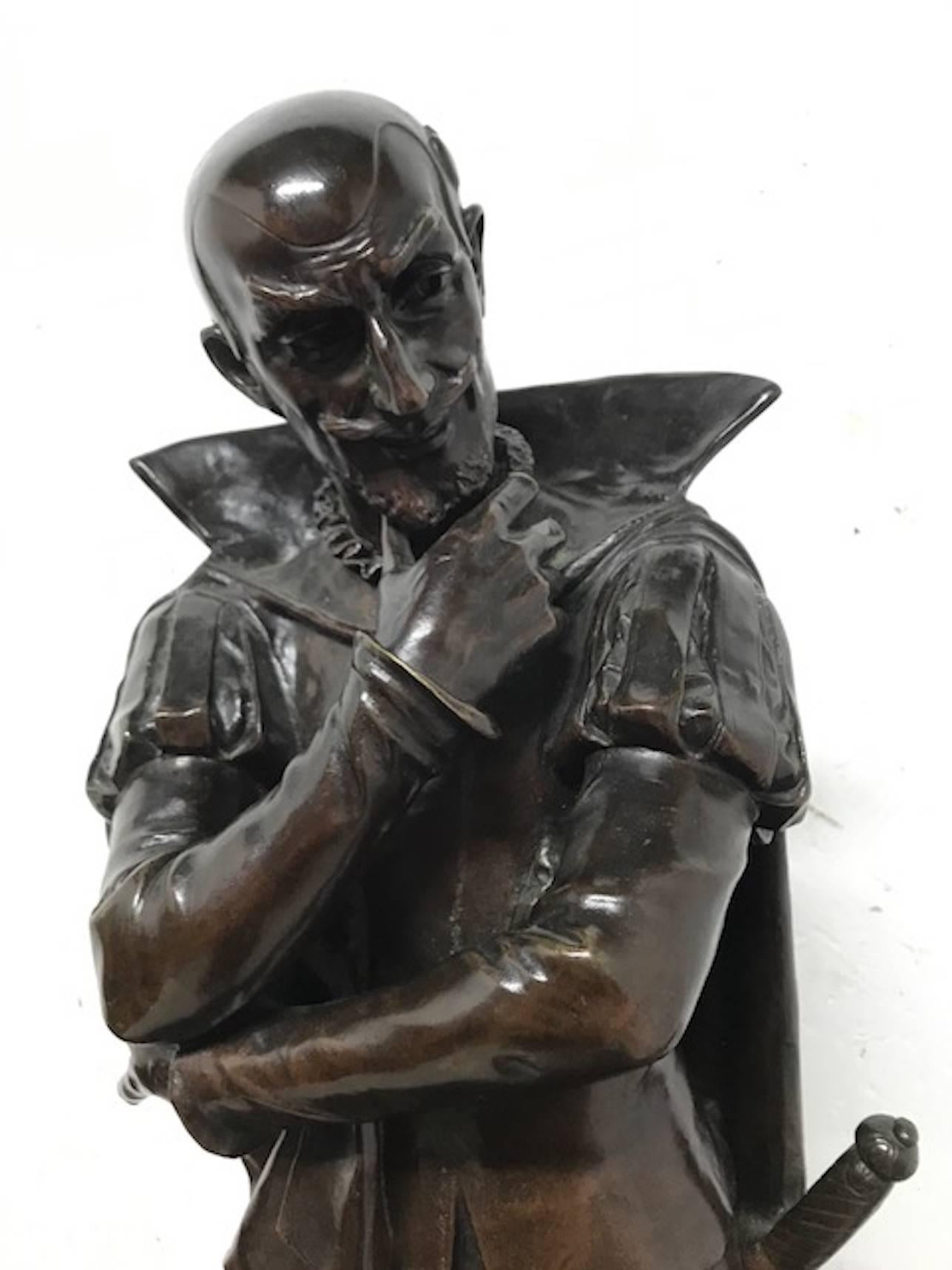 An 18th century bronze statue of a Shakespearian character in period dress with pensive look. Signed Pierre Marie Francis Oge (1849-1913) Paris. Standing on circular base.