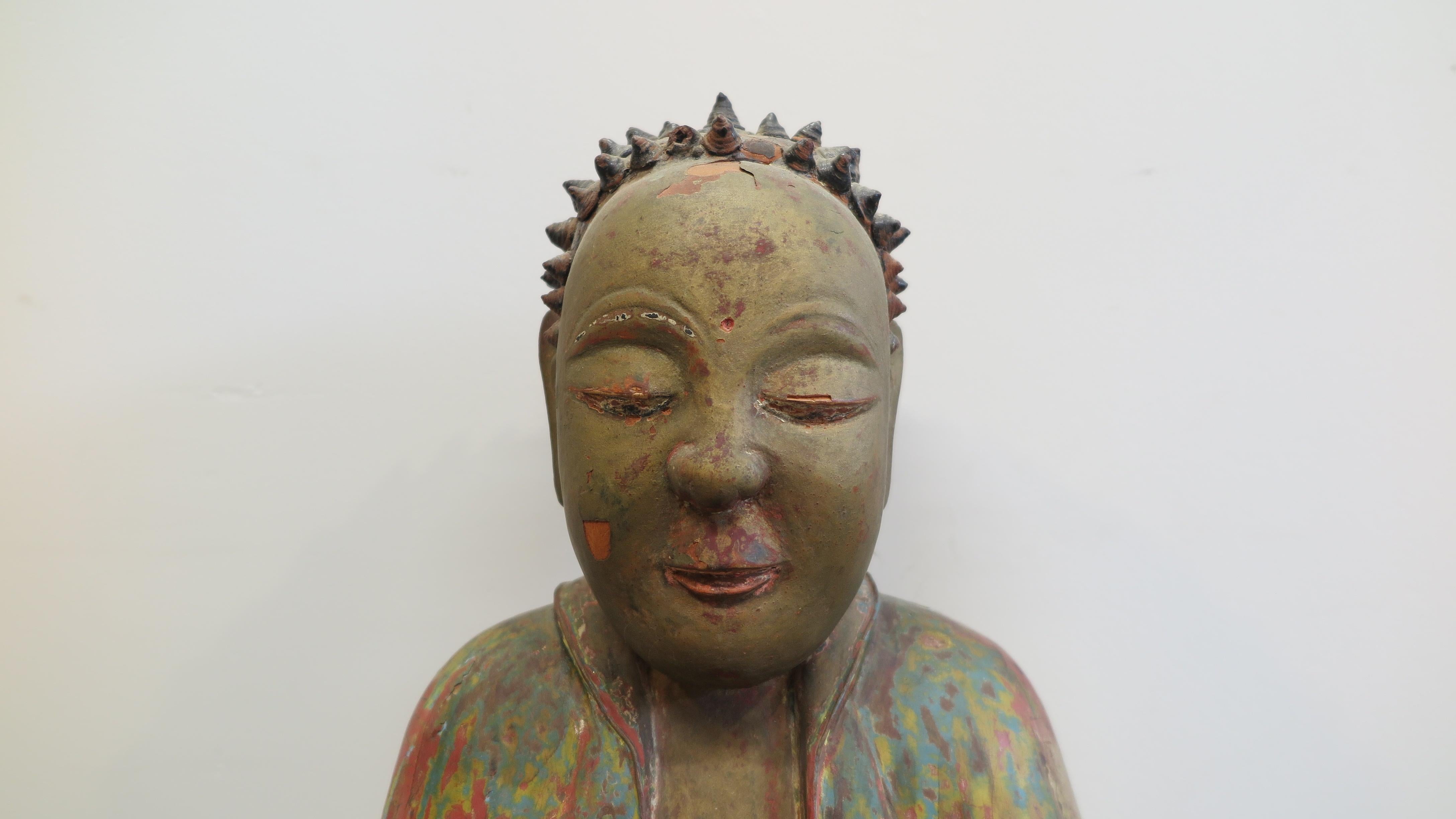 18th century Carved Wood Buddha. Chinese antique Buddha Statue of carved wood. Gesso like coating to wooden surface, with pigments and gilding. Dry Lacquer conical hand formed cones to the head representing the hair of the Buddha, with loss as