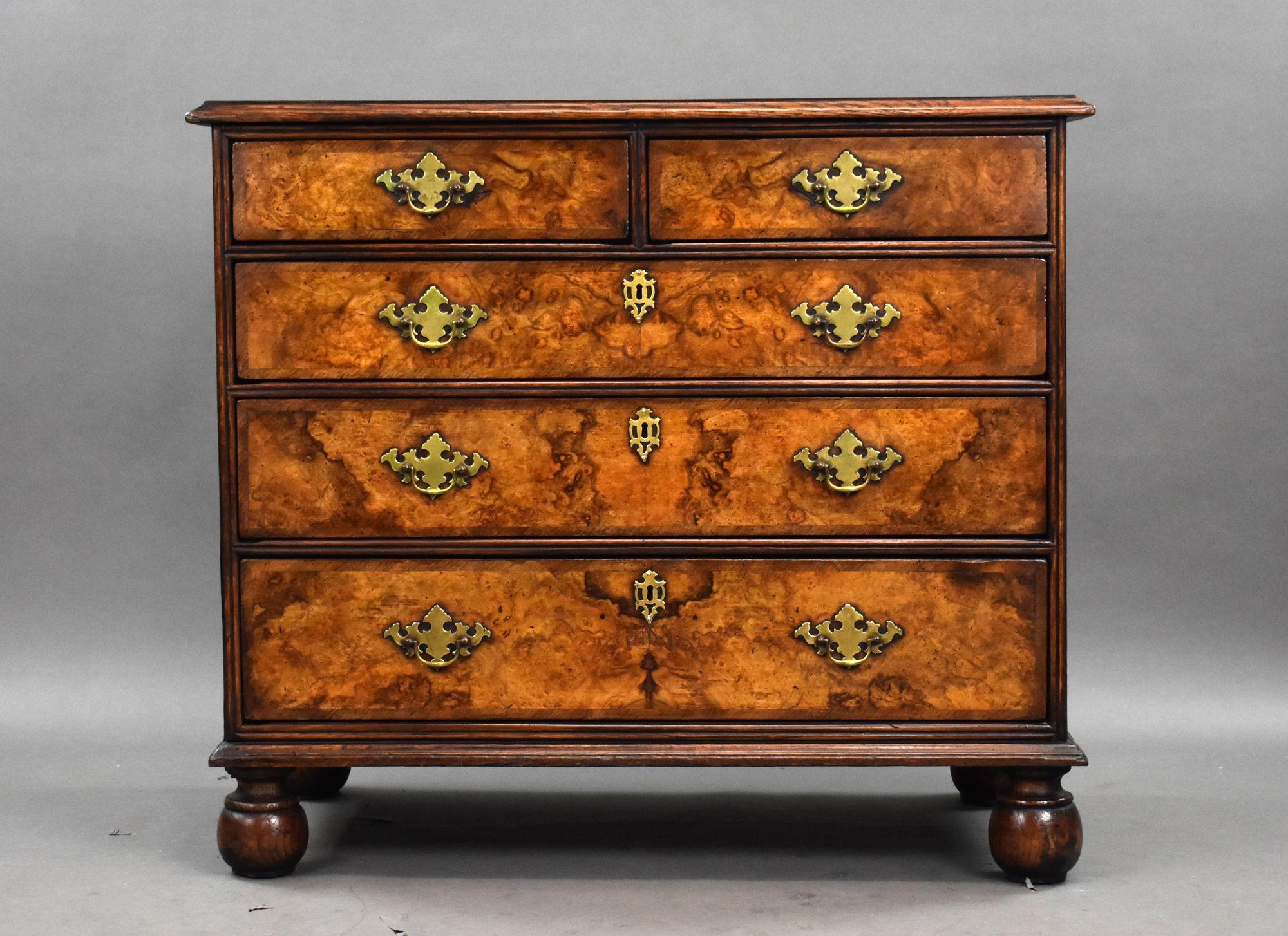 18th Century Burr Walnut Chest of Drawers
A striking example of 18th-century craftsmanship, this burr walnut chest of drawers combines rich materials with timeless elegance. The deep patina, figured veneers, and bold brass fittings all reflect the