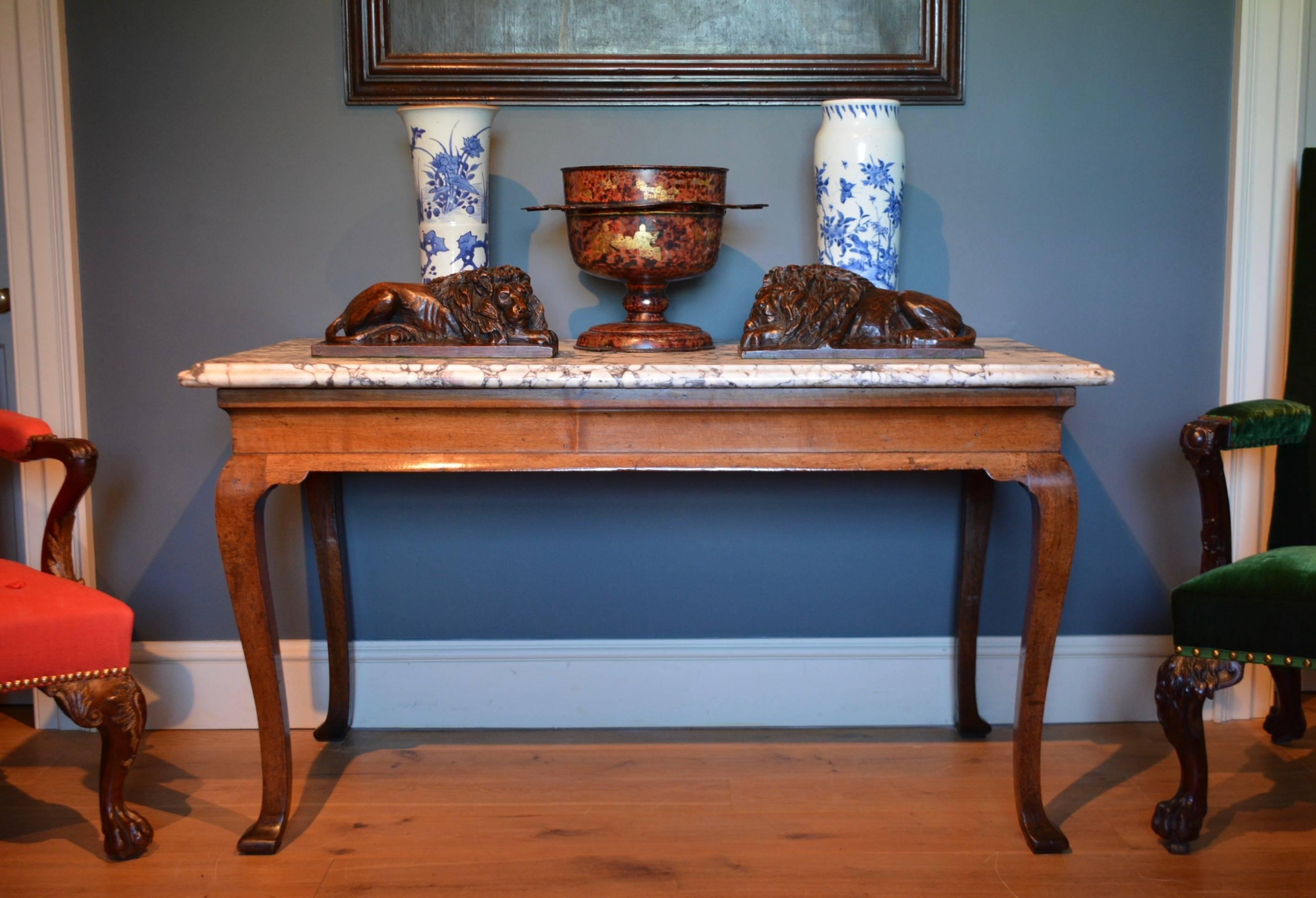 A George II cabriole leg Virginia walnut marble-top side table, the 18th century breccia marble top above a cavetto frieze supported on four squared cabriole legs, all of excellent surface and color.