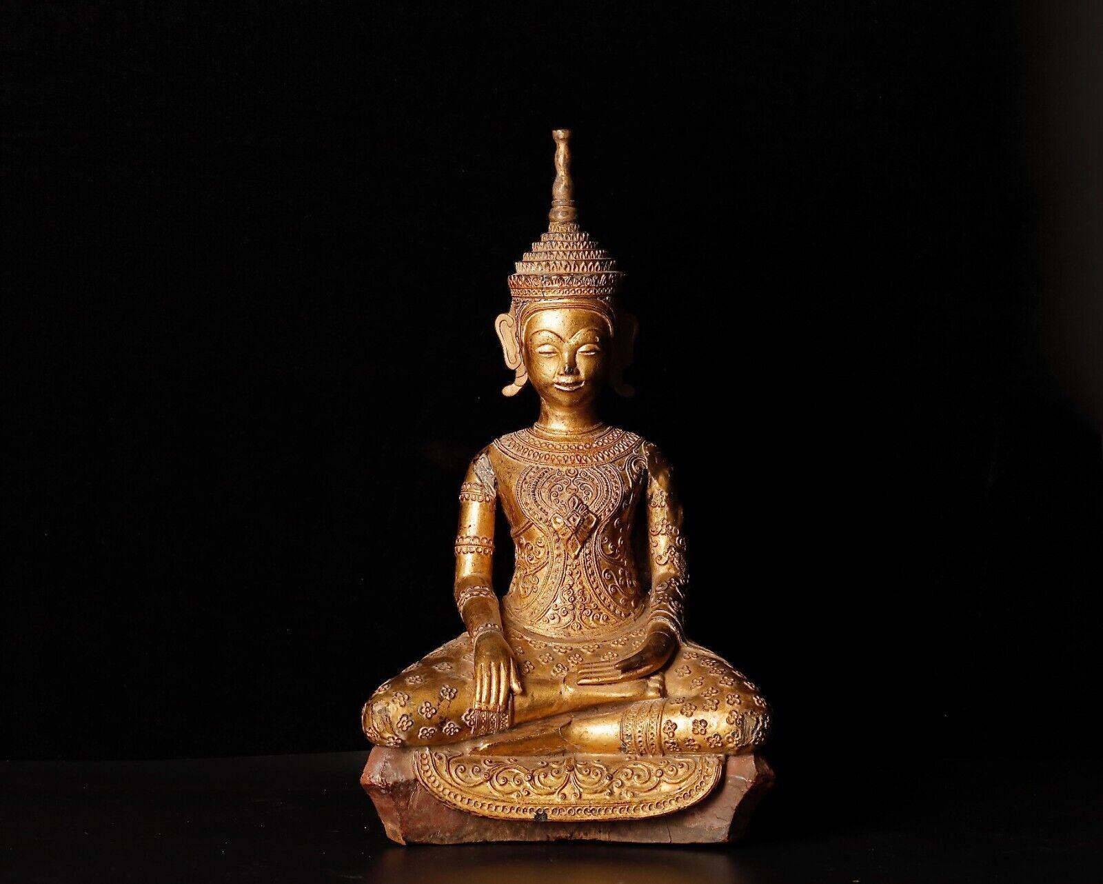 Presenting a remarkable wooden Buddhist sculpture hailing from Cambodia, characterized by its rarity and historical significance. This sculpture features gilded teak wood with exquisite lacquer applications, showcasing the fine craftsmanship and