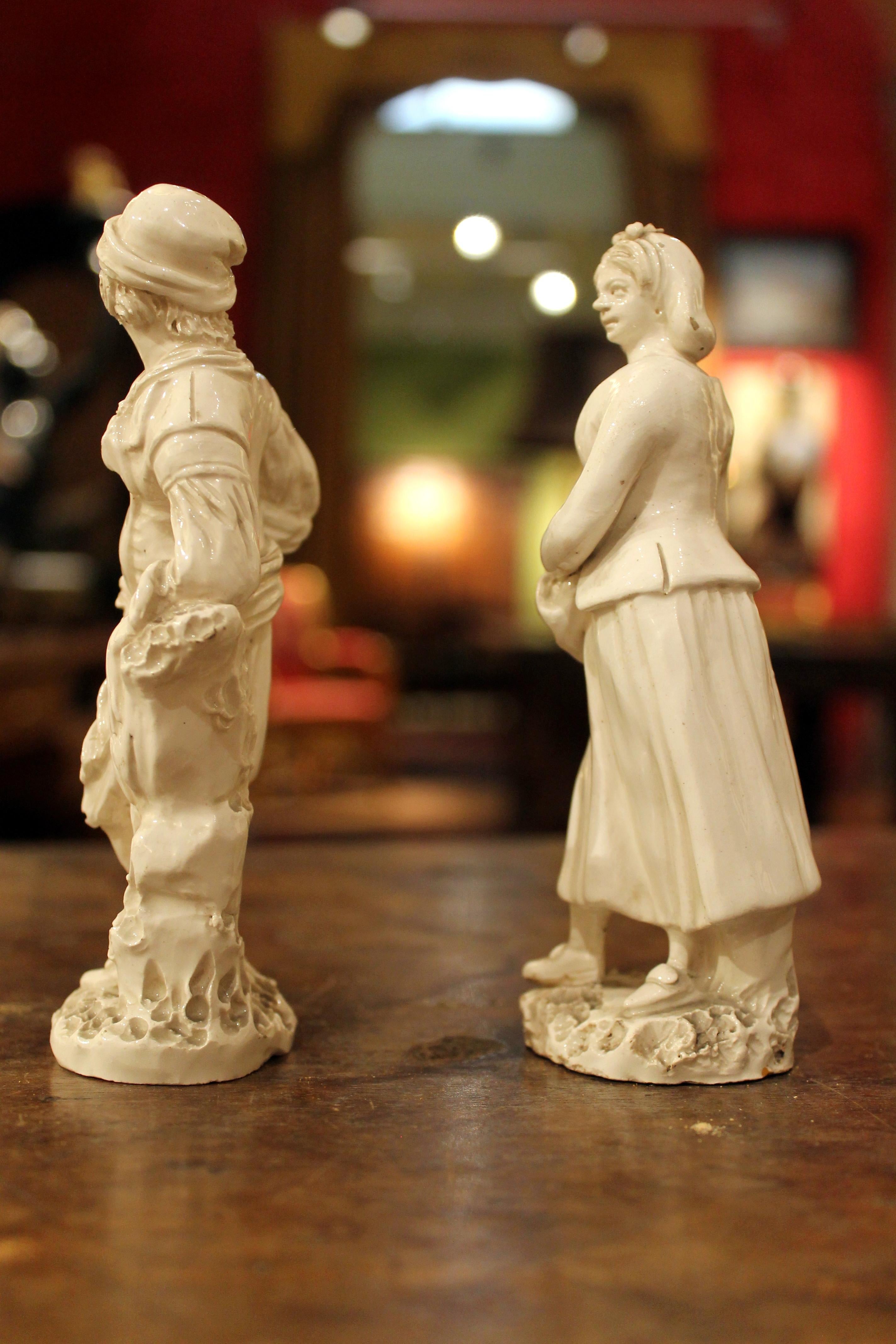 Paire de figurines en porcelaine blanche de Naples, véritable Fabbrica Ferdinandea, de la fin du XVIIIe siècle, représentant une dame et un homme, modelées à la main en ronde-bosse. Ce joli couple de statuettes en blanc représente un vendeur de