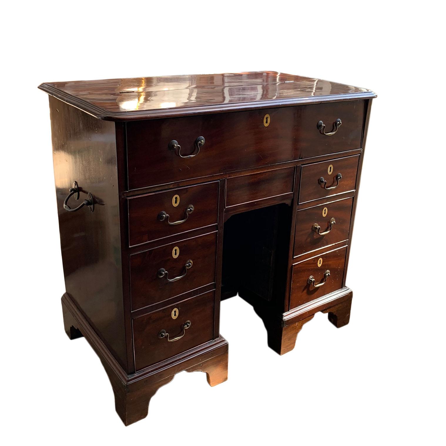A George III period mahogany kneehole captains desk. Rare example of 18th century campaign furniture. Rich, dense Cuban mahogany inlaid with ivory escutcheons with period brass. Probably made on the Channel Islands. Britain, Circa 1760. Note,