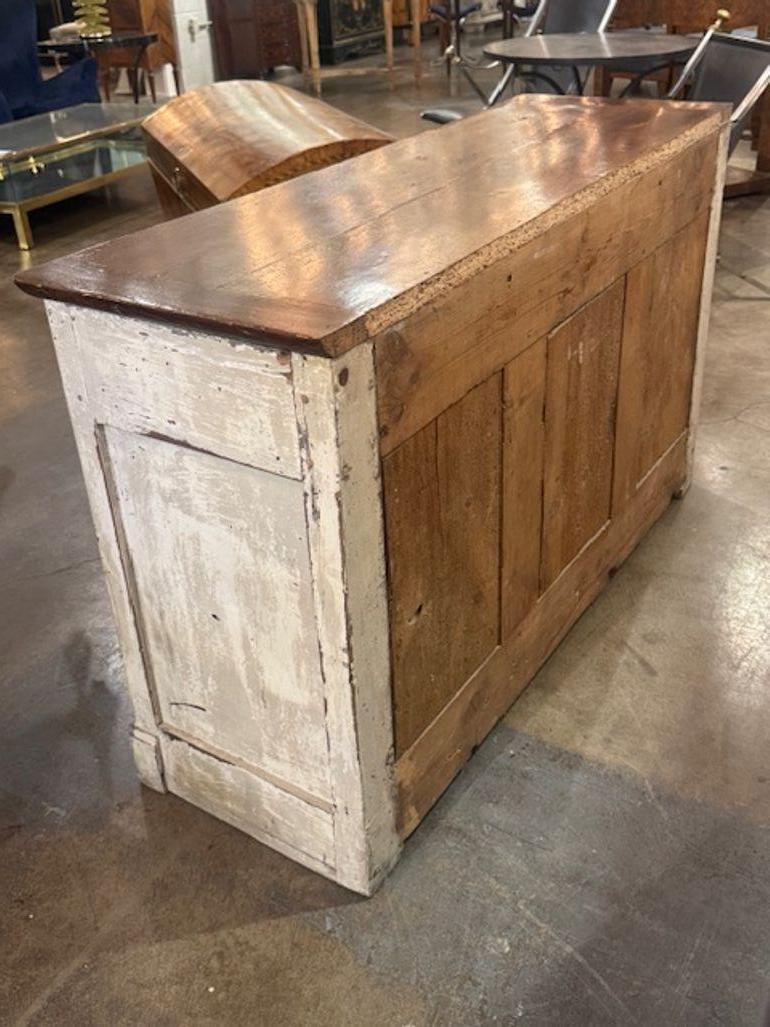 The 18th century carved and painted  oak French buffet is a stunning piece of furniture that adds a real touch of charm to any home. This beautiful sideboard showcases traditional French craftsmanship and design, making it a timeless addition to any