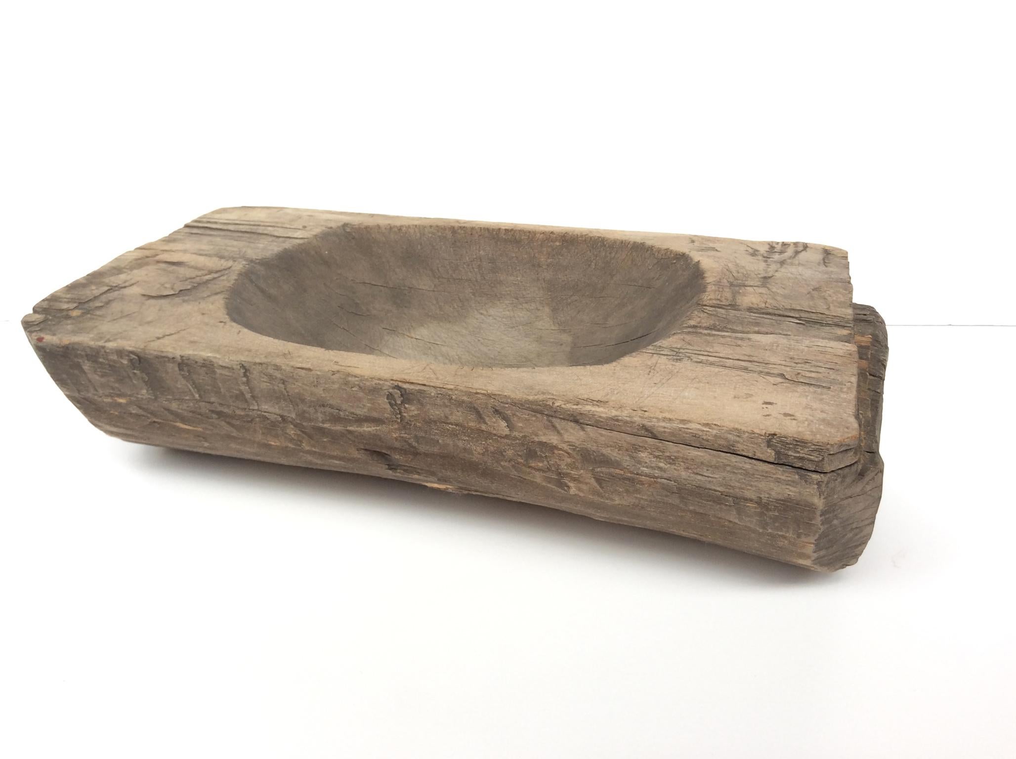 A rustic, beautifully aged 18th Century trencher. Trenchers were used as tableware for serving food. This particular trencher was carved from chestnut wood. The marks and wear of the wood give the trencher a sculptural texture and a very tangible