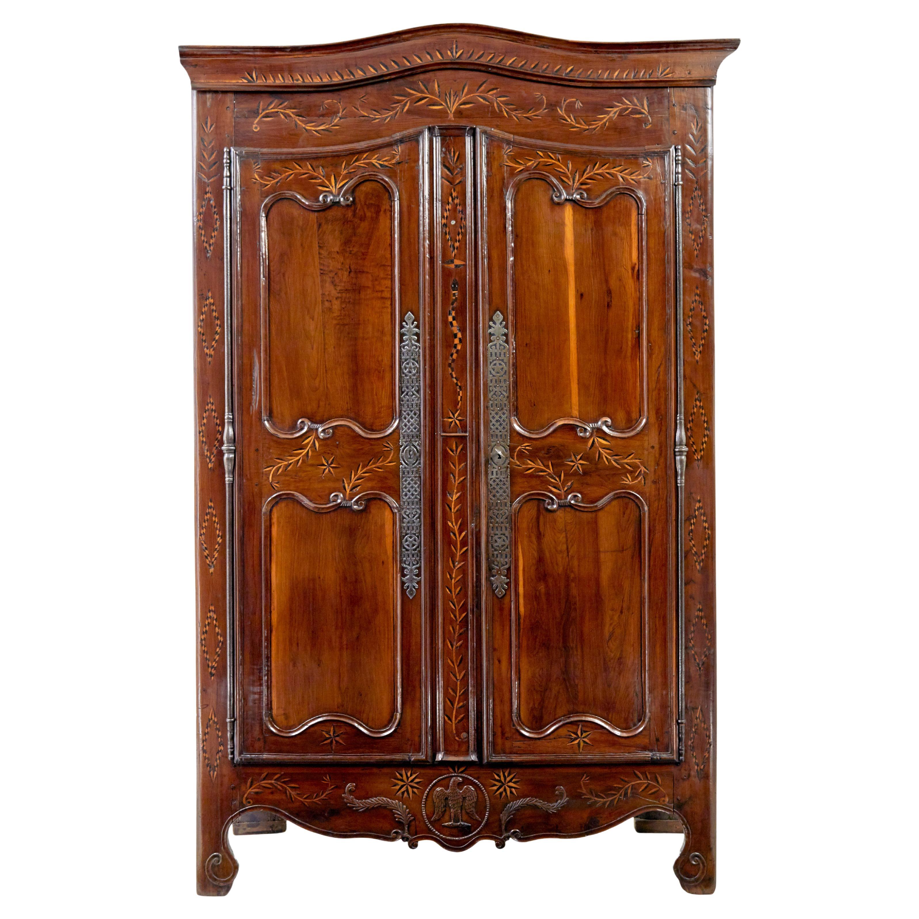 18th century carved French yew and chestnut armoire For Sale
