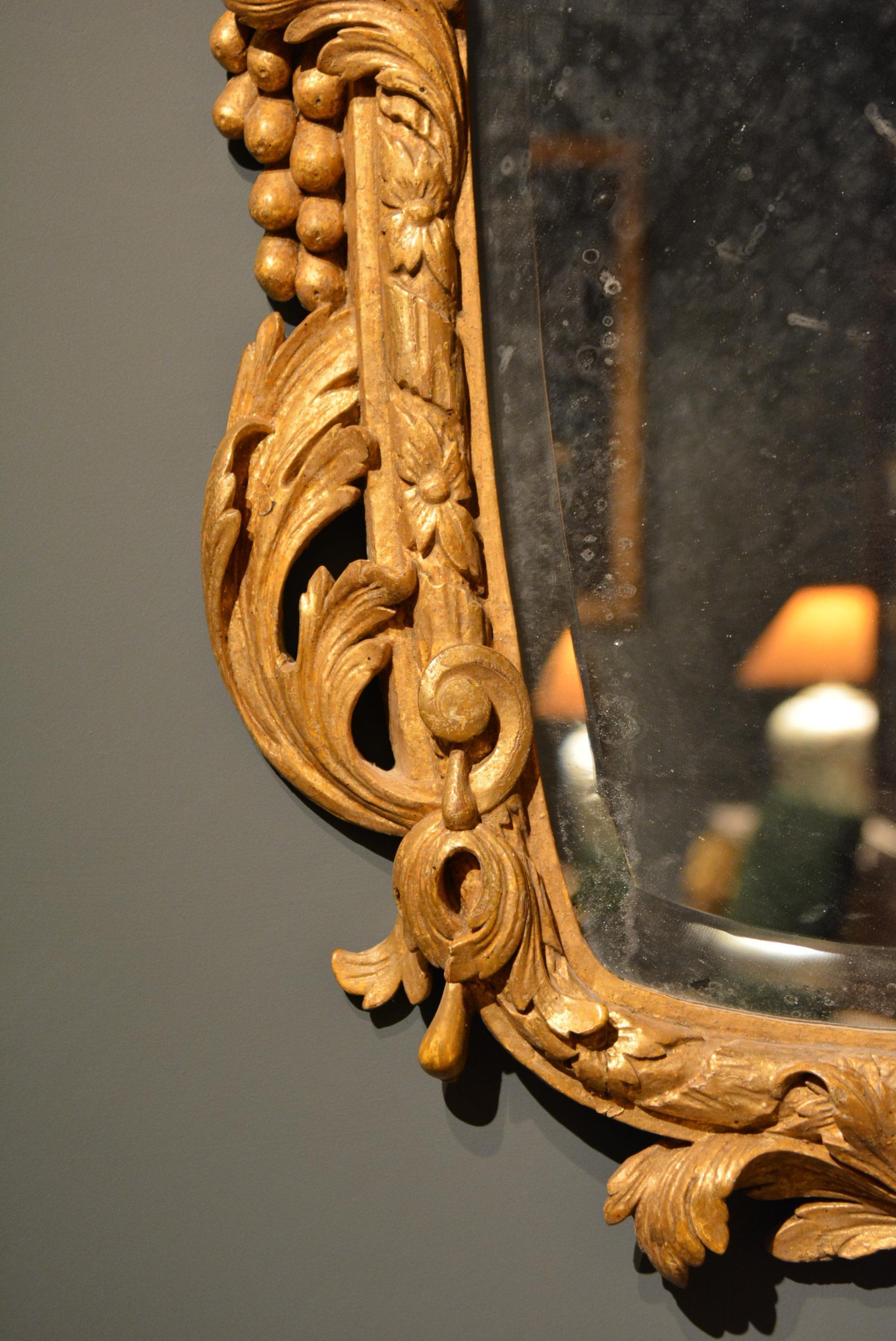 English 18th Century Carved Giltwood Mirror of Unusual Form with Shell Cresting For Sale
