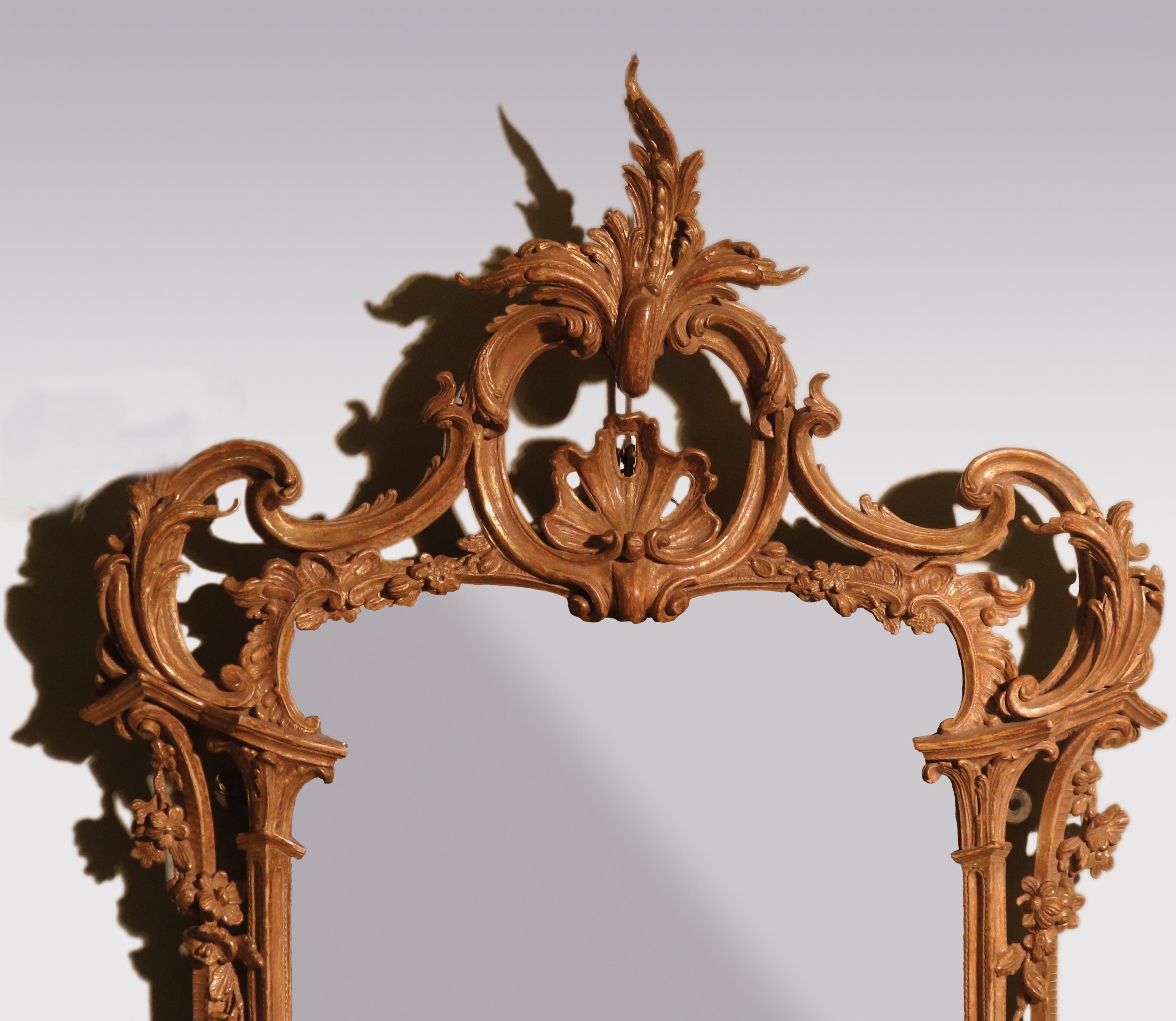 A fine quality crisply carved Mid-18th Century giltwood Mirror, having c-scroll acanthus and flower decoration throughout, contained in 'Chinese pagoda' frame.